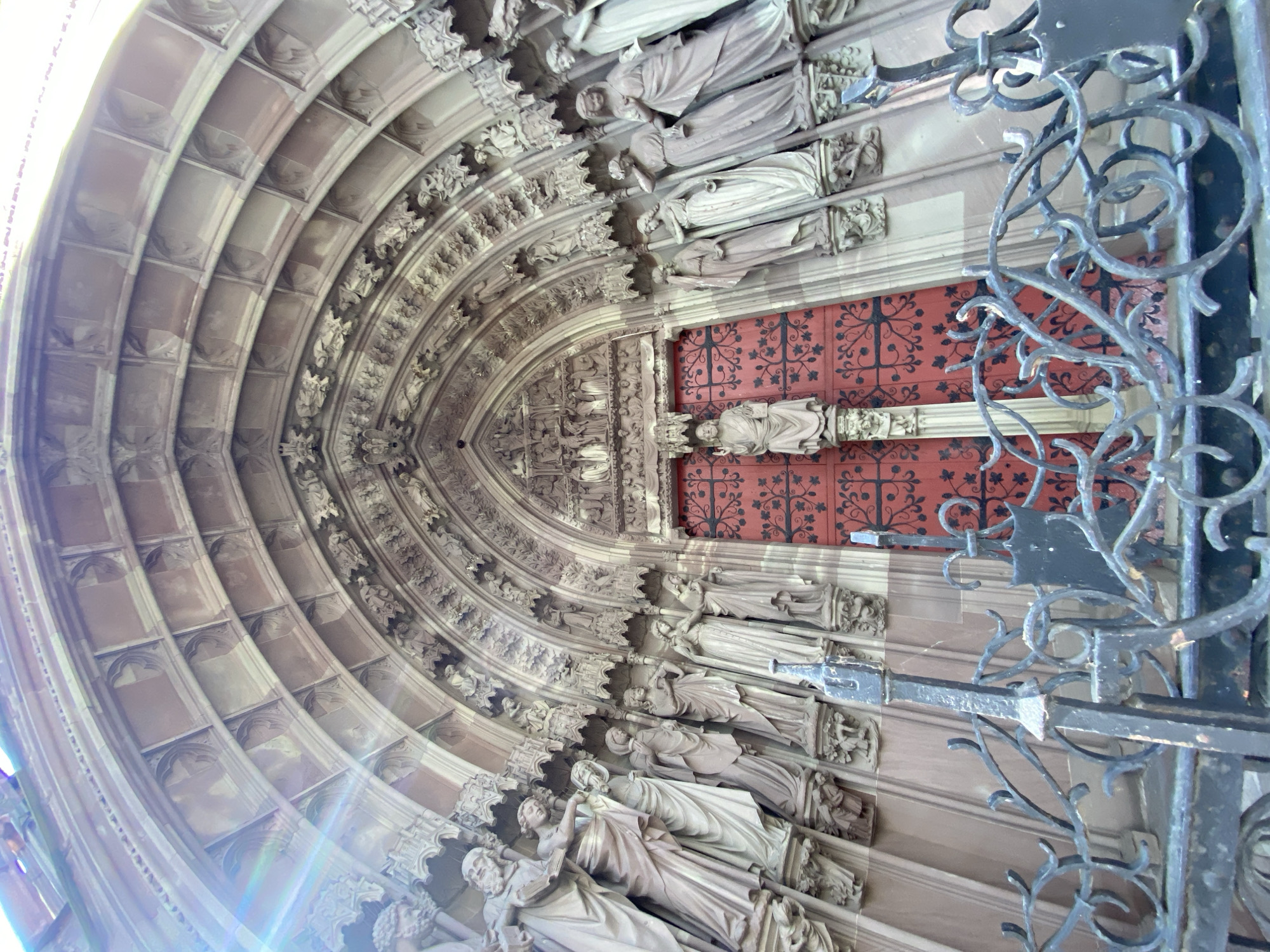 Visitor documents ornate cathedral architecture in Strasbourg