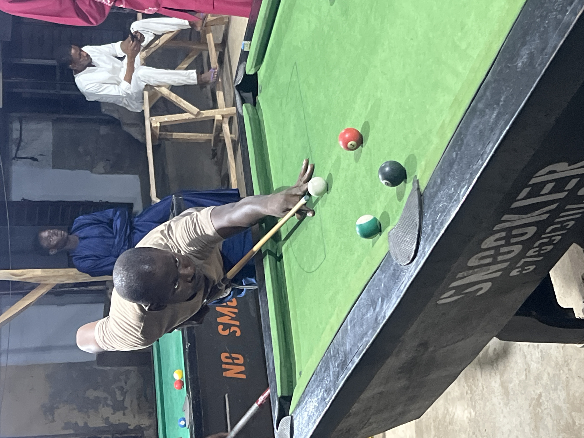 Evening pool games documented at Minna recreational hall