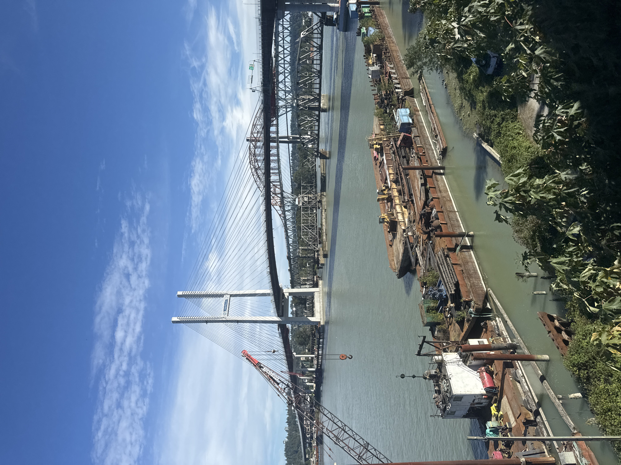 Moored barges on the Fraser River under clear skies