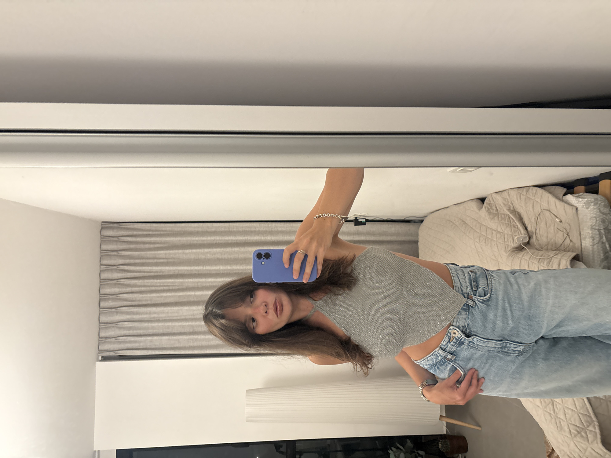Mirror selfie in a Tel Aviv elevator, gray halter and wide-leg jeans