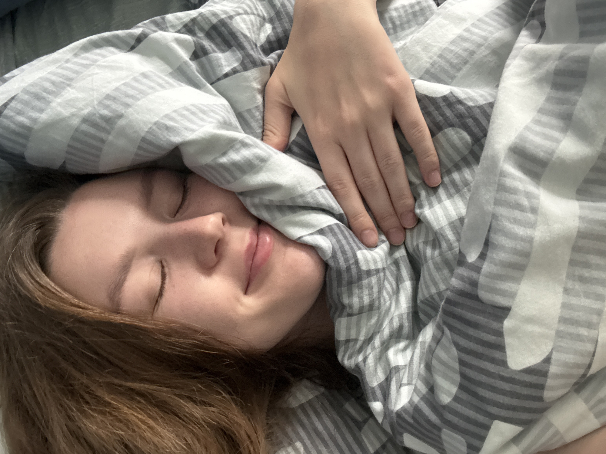 Morning moments with sleeping woman and playful kittens in Izhevsk