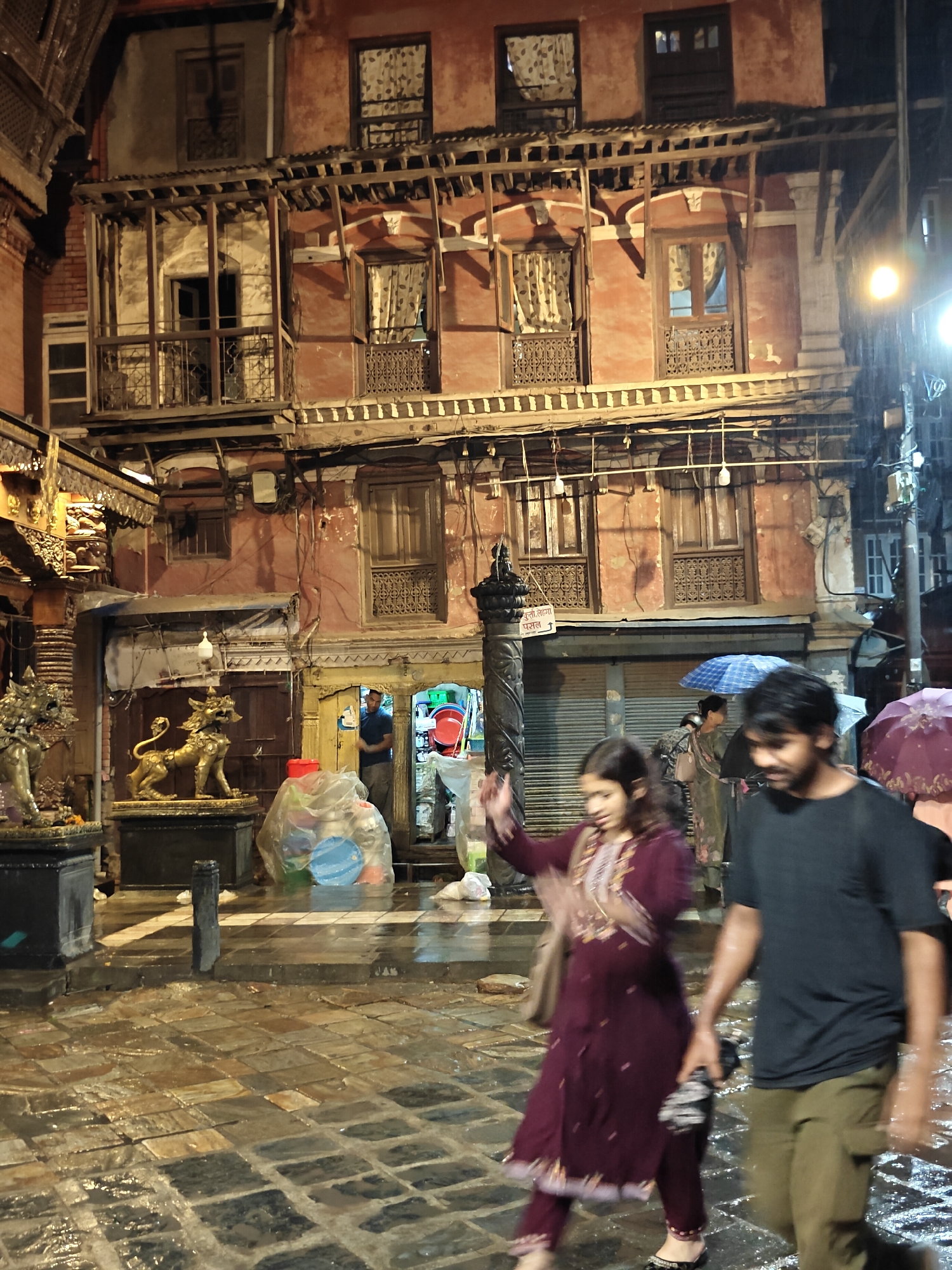 Rainy night at a Kathmandu temple complex, streets and shrines