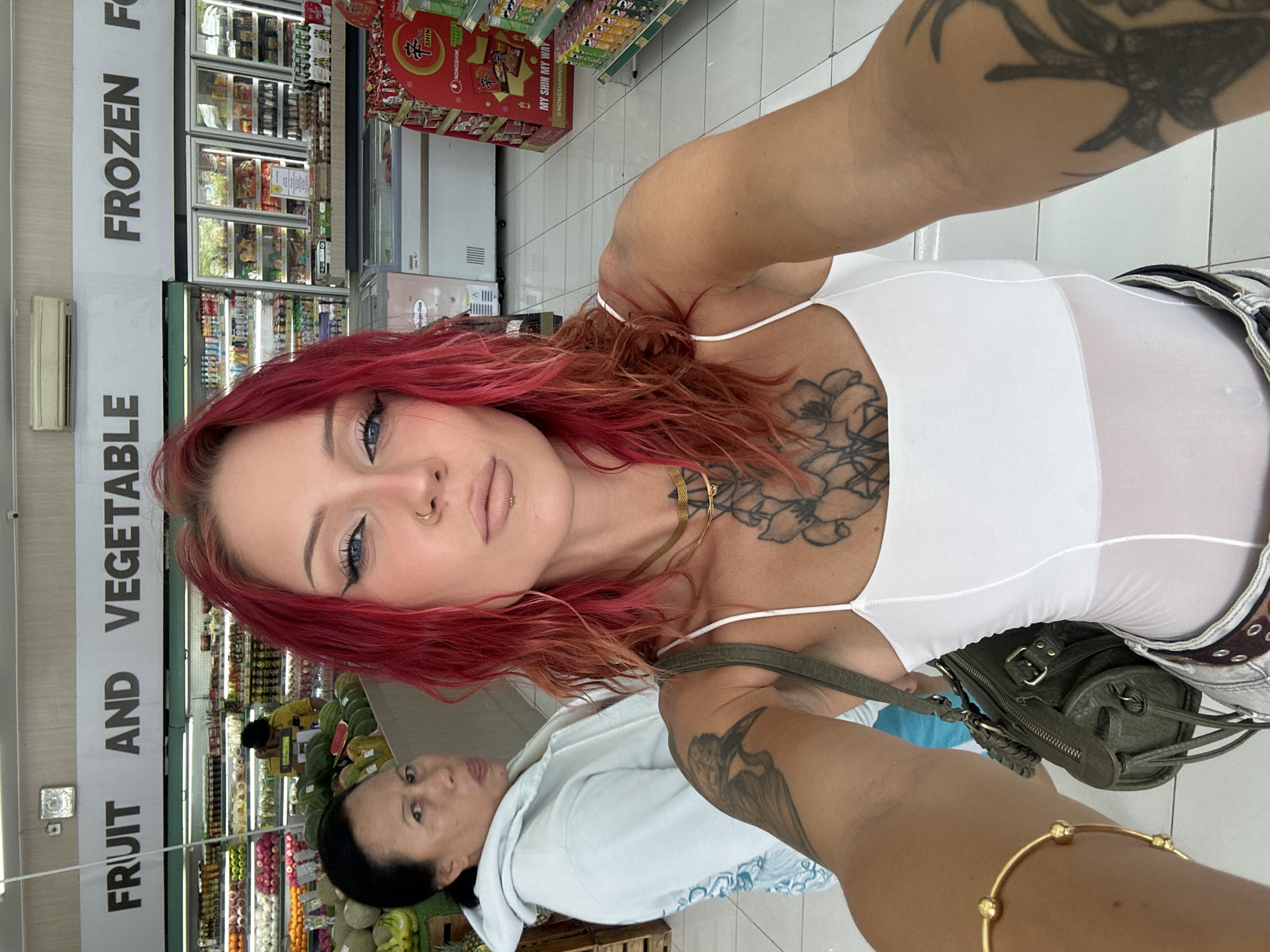 Woman takes selfies in Indonesian grocery store early morning