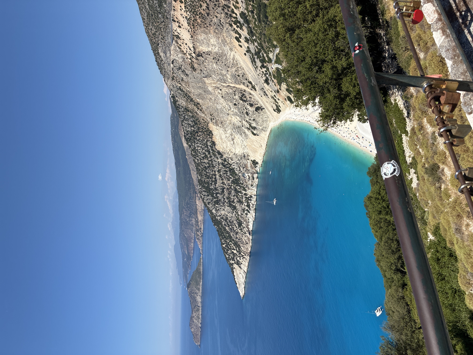 Looking down on Myrtos Beach's crescent shoreline from above