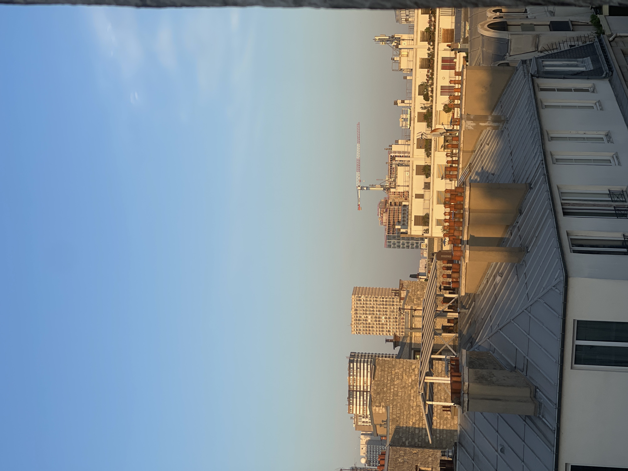 Paris rooftops at golden hour, Haussmann meets construction