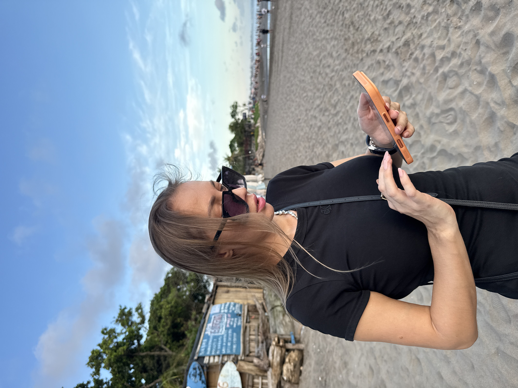 Woman with smartphone spotted on North Kuta beach