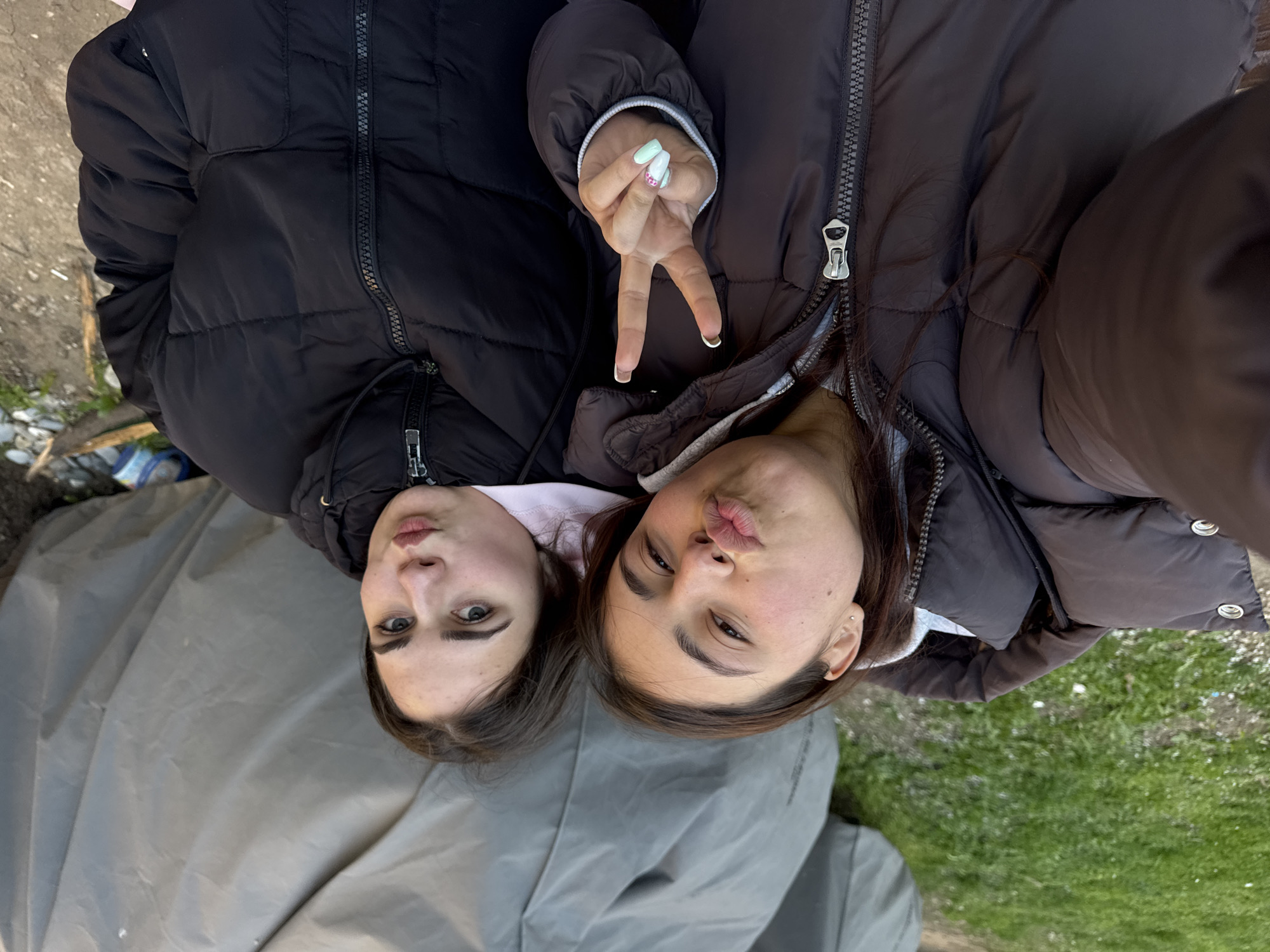 Two women take selfie on tarpaulin in Sofia