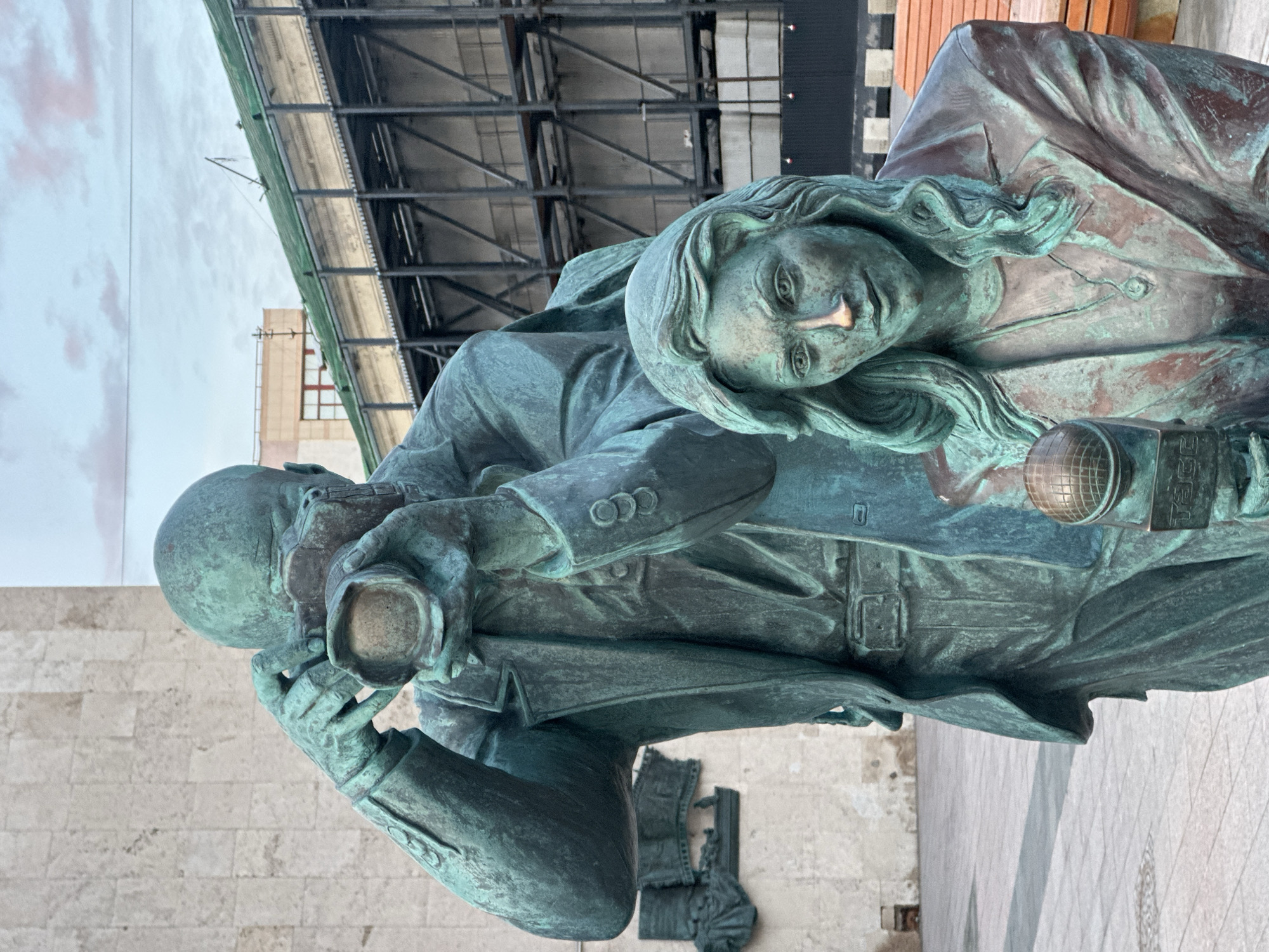Bronze photographer monument observed on Moscow sidewalk