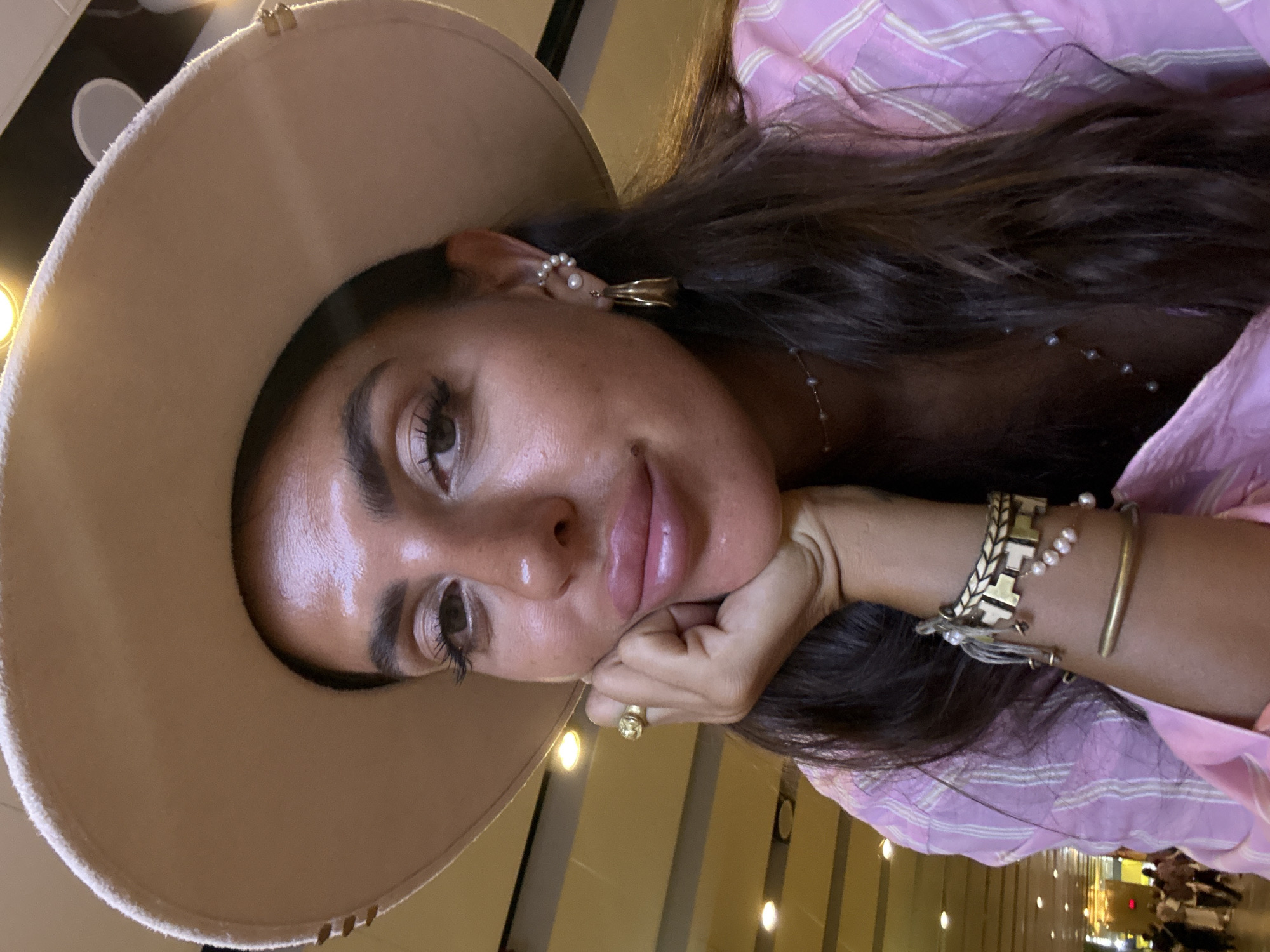 Woman in pink outfit documents airport journey in Kuta