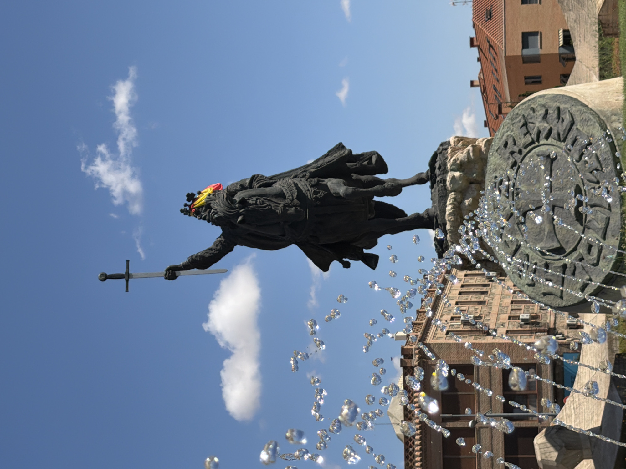 Toledo's Alfonso VI statue and historic city center, summer morning
