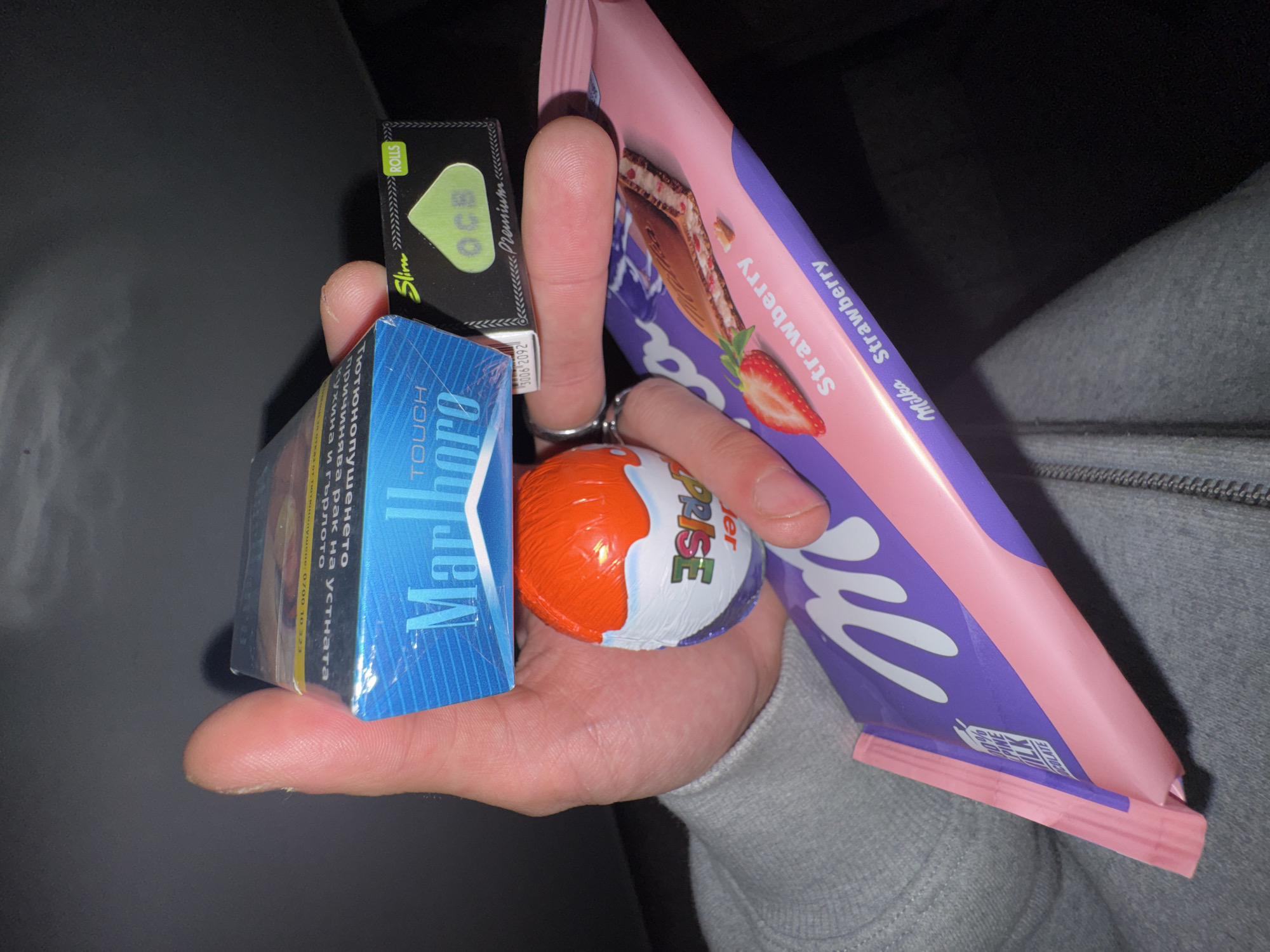 Person holds cigarettes and rolling papers in Sofia