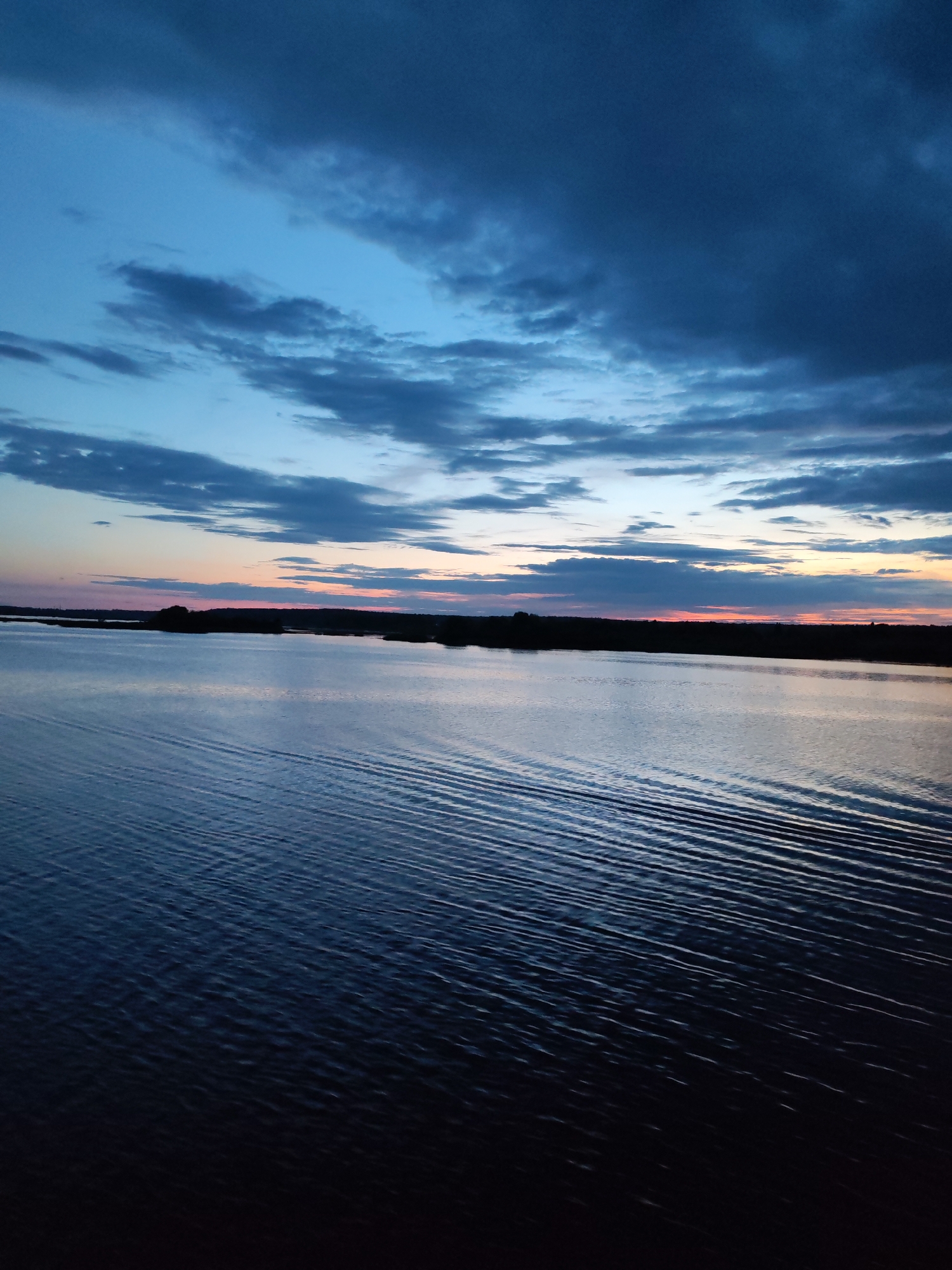 Dusk settles over Rybinsk's waterfront in deep blues