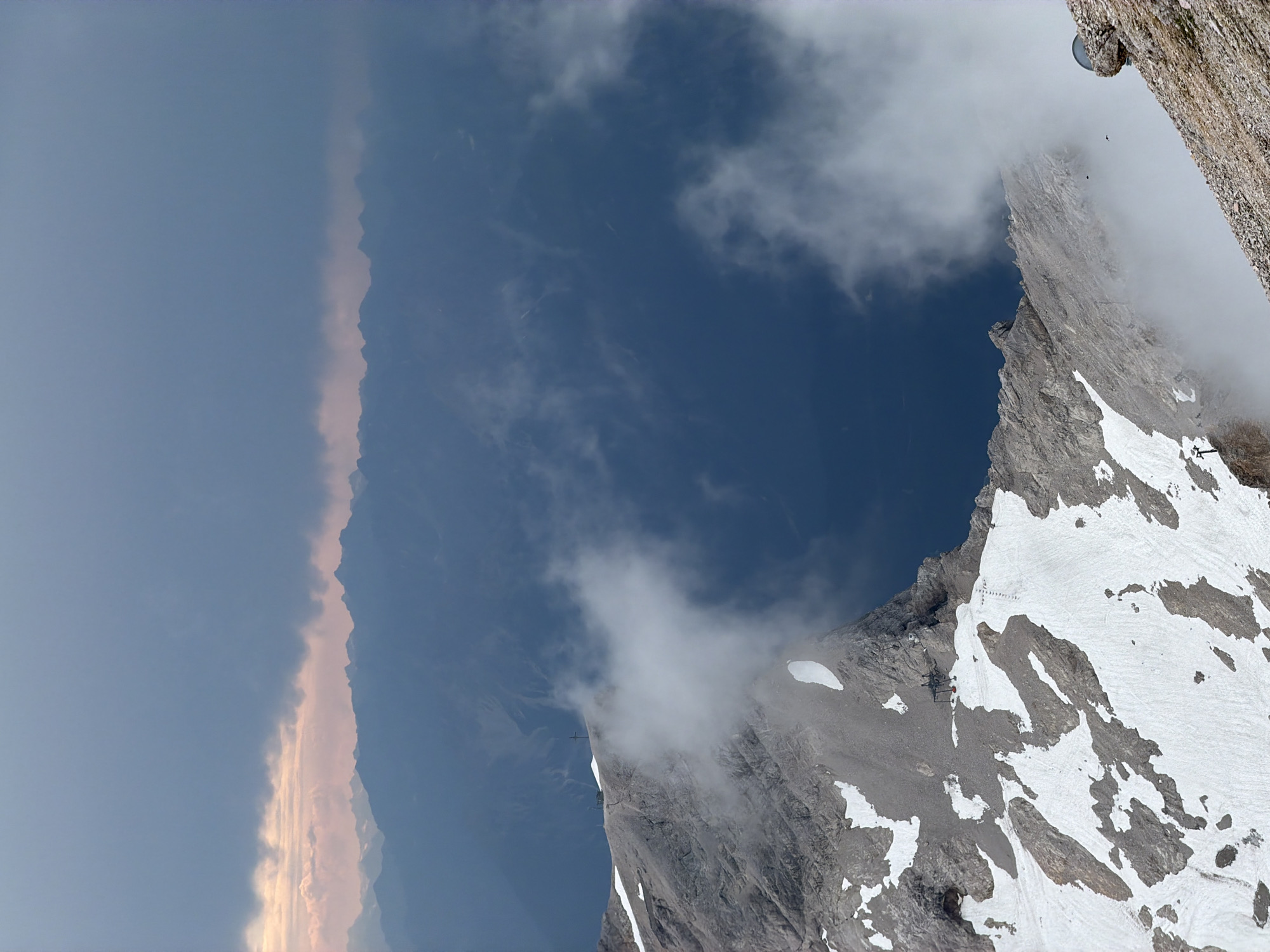 Rocky alpine peaks and hazy ridgelines above Grainau