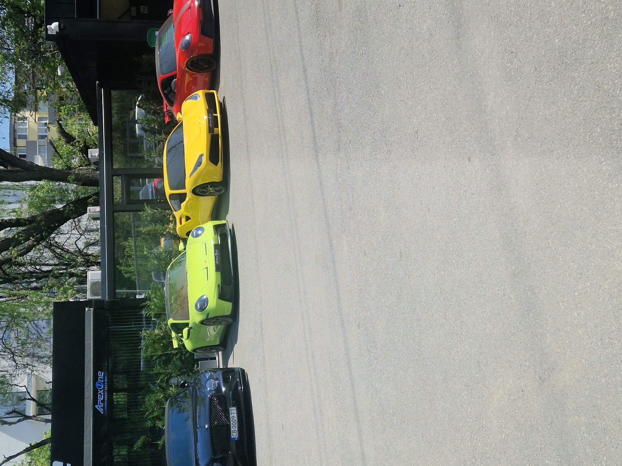 Luxury cars including Aston Martin spotted in sunny parking area