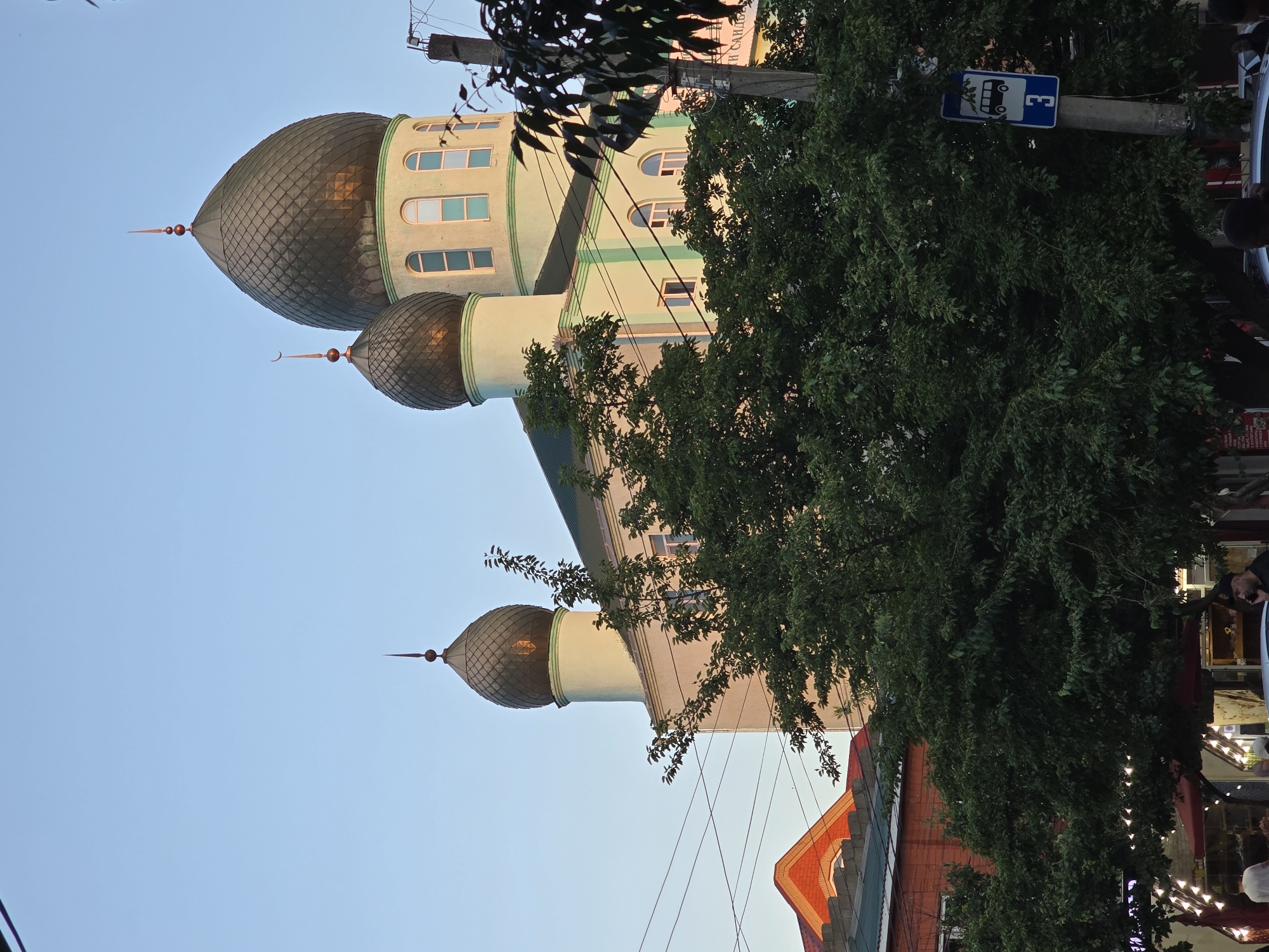 Mosque exterior and small objects on a dark speckled surface