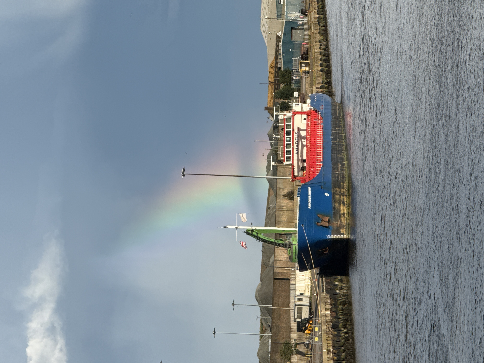 Rainbow appears over Great Yarmouth port during afternoon
