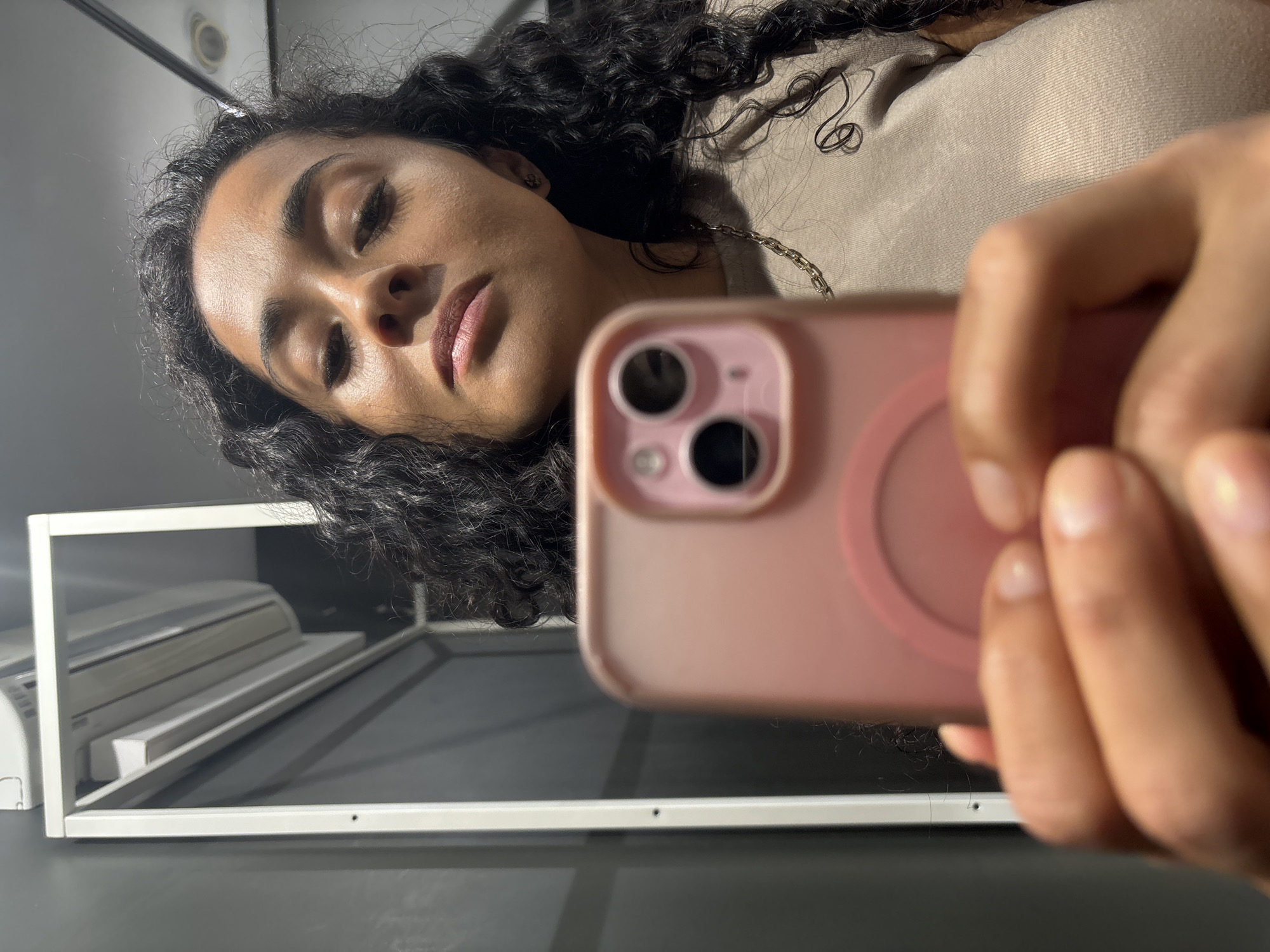Woman takes selfies in Luxembourg clothing store fitting room