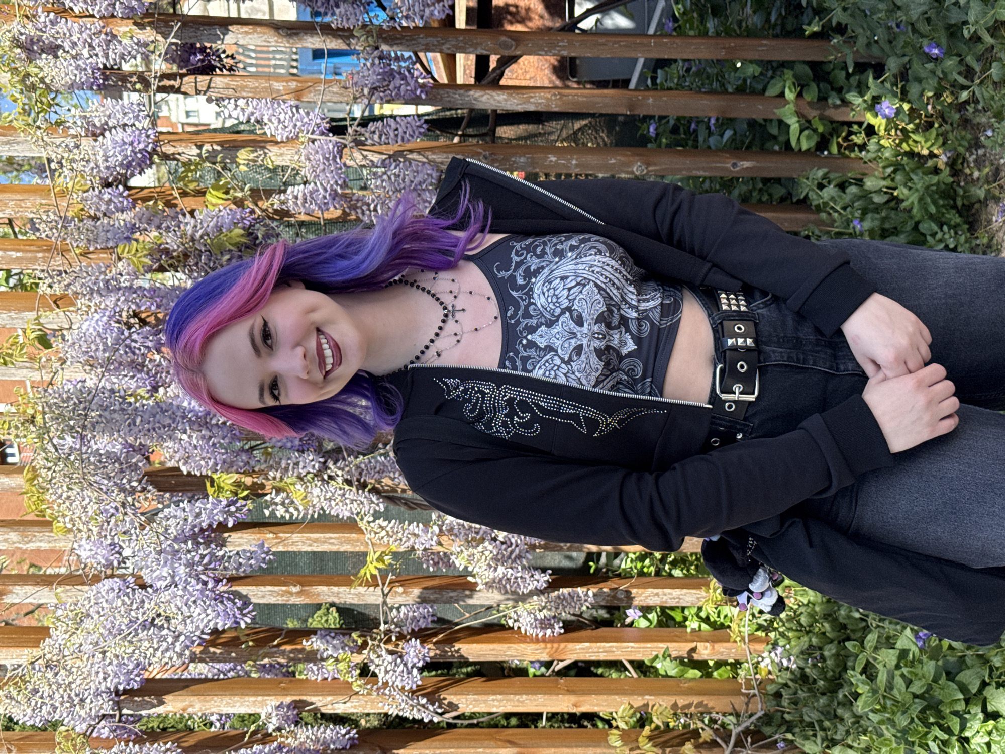 Woman takes selfies amid wisteria blossoms in Madrid