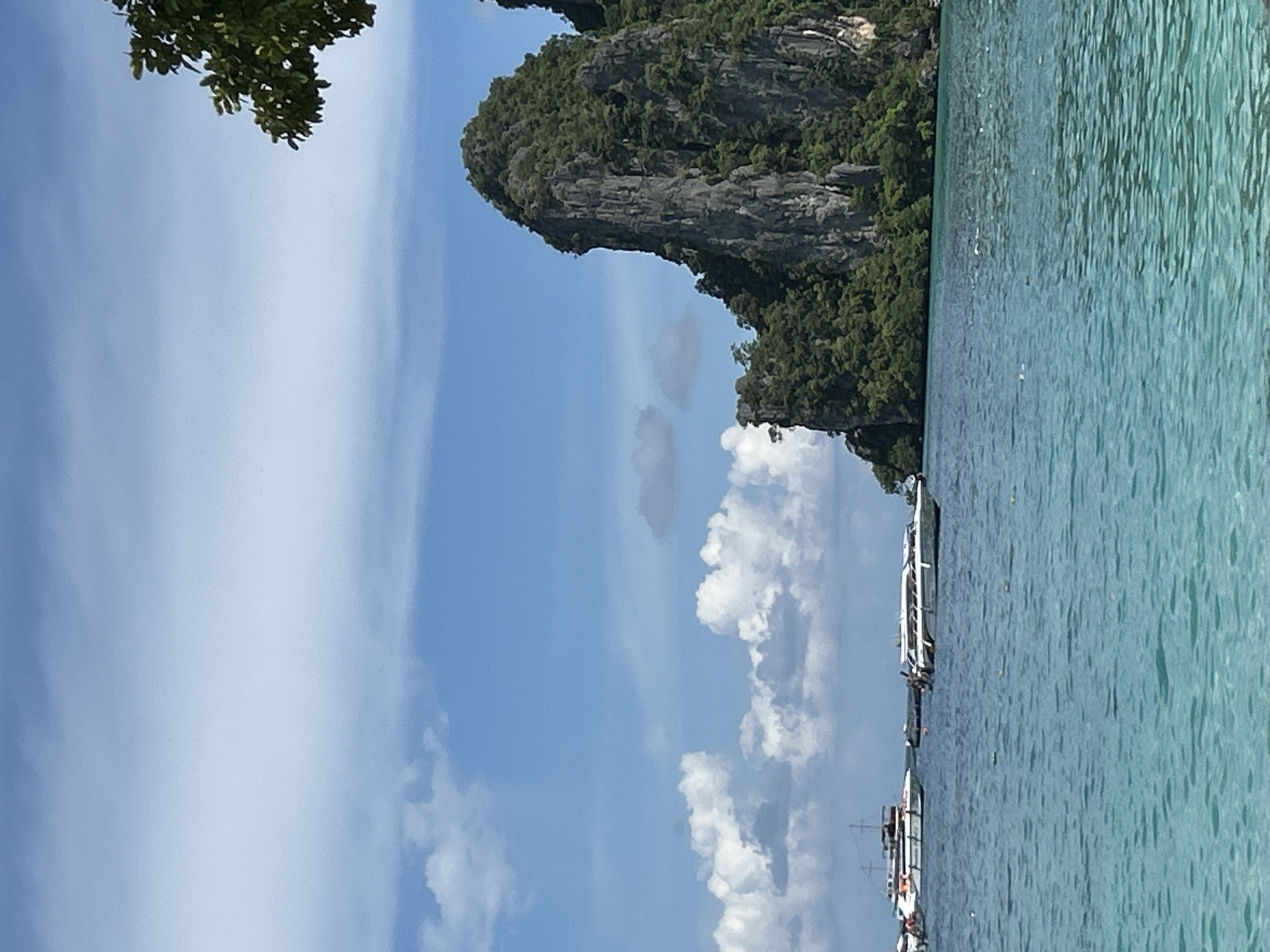 Quiet morning on the Ao Nang shoreline, boats on the bay