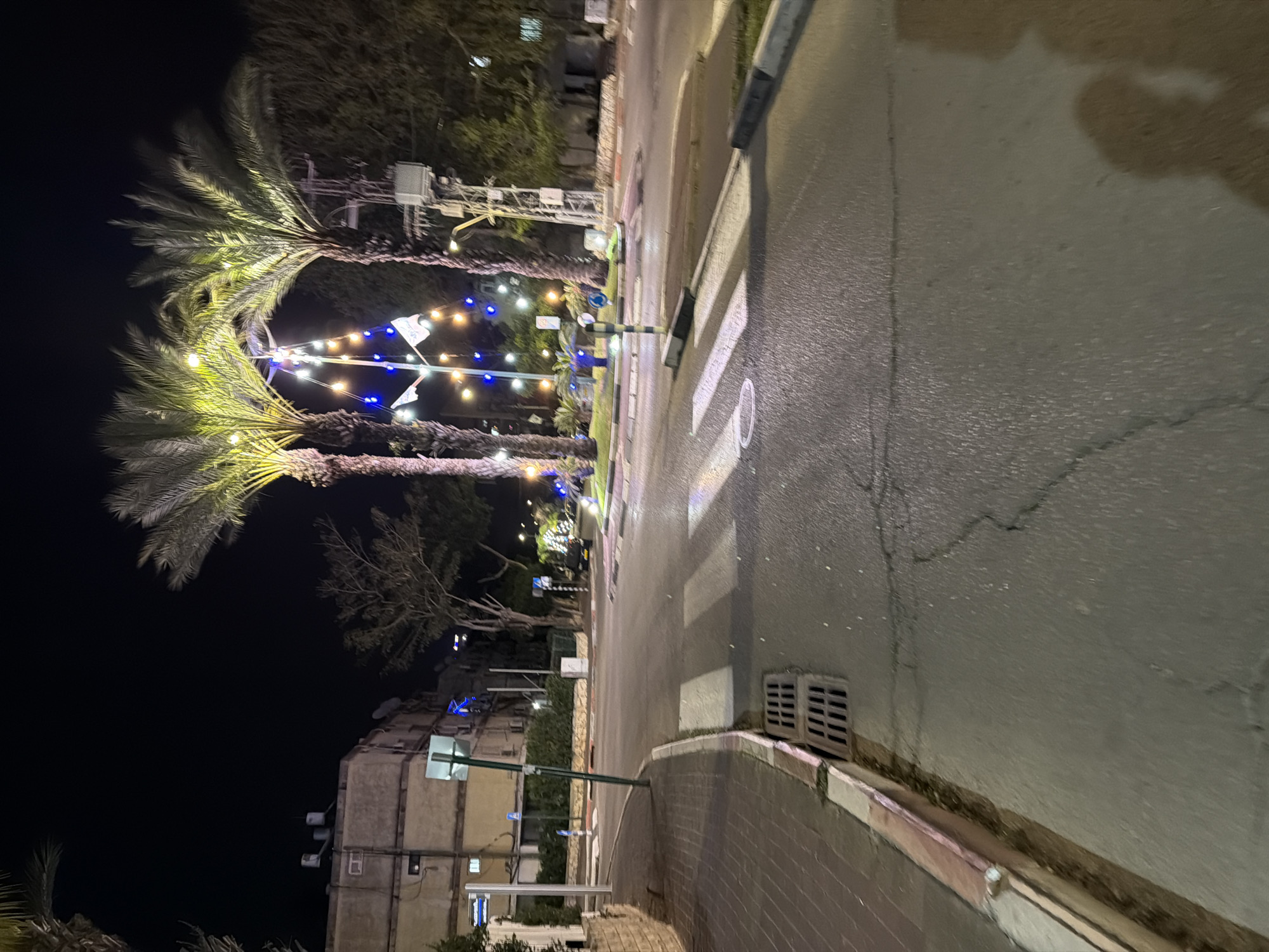 Decorated street scene observed in Kiryat Bialik after dusk