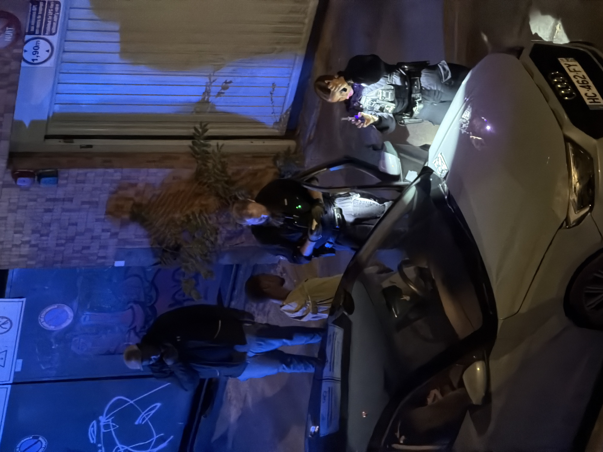 Late-night police stop around a silver Audi in Paris