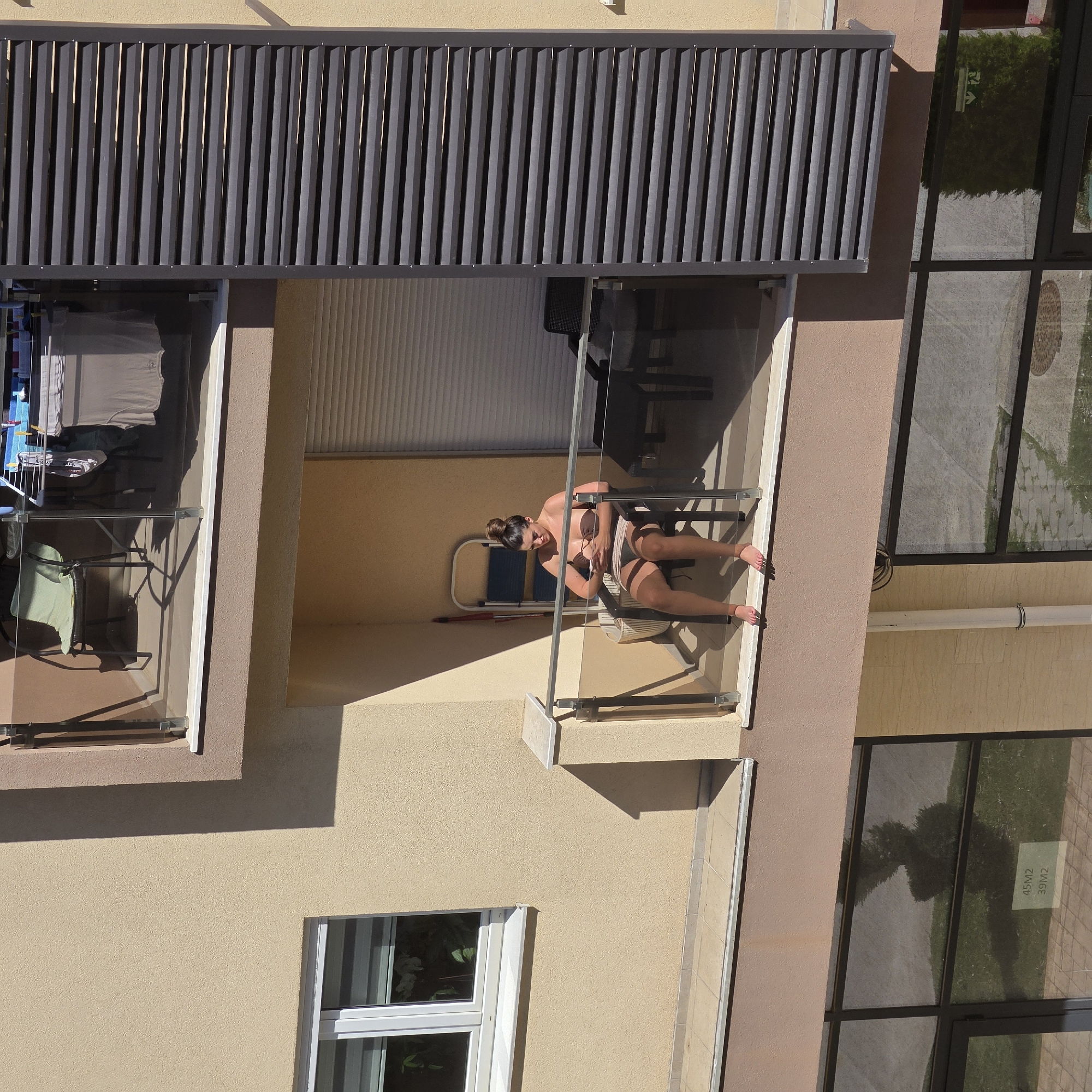Woman sunbathes on balcony in Podgorica morning
