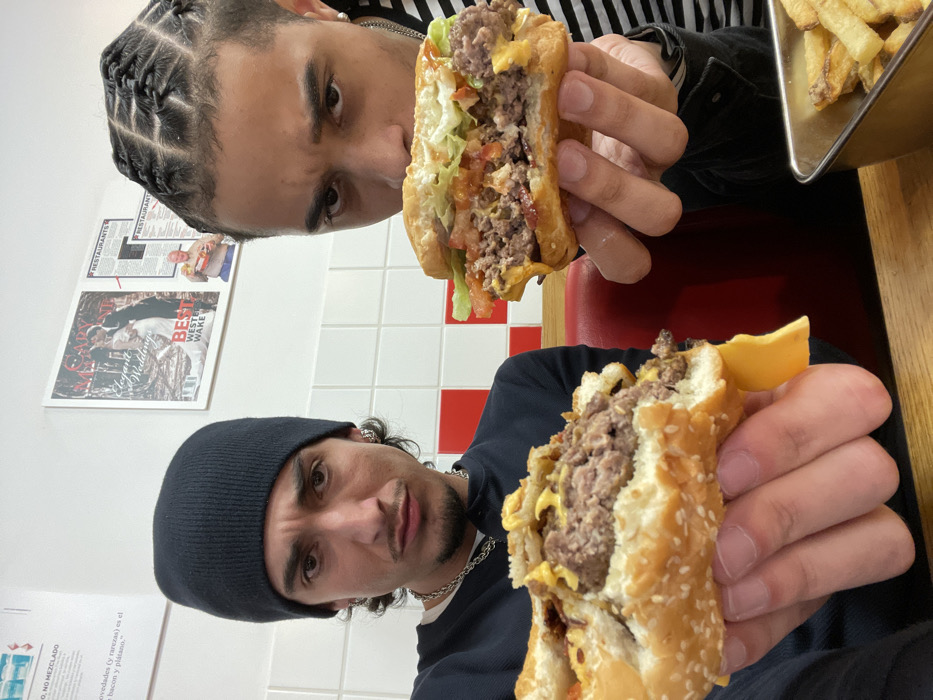 Two men dine at Five Guys restaurant in Paris