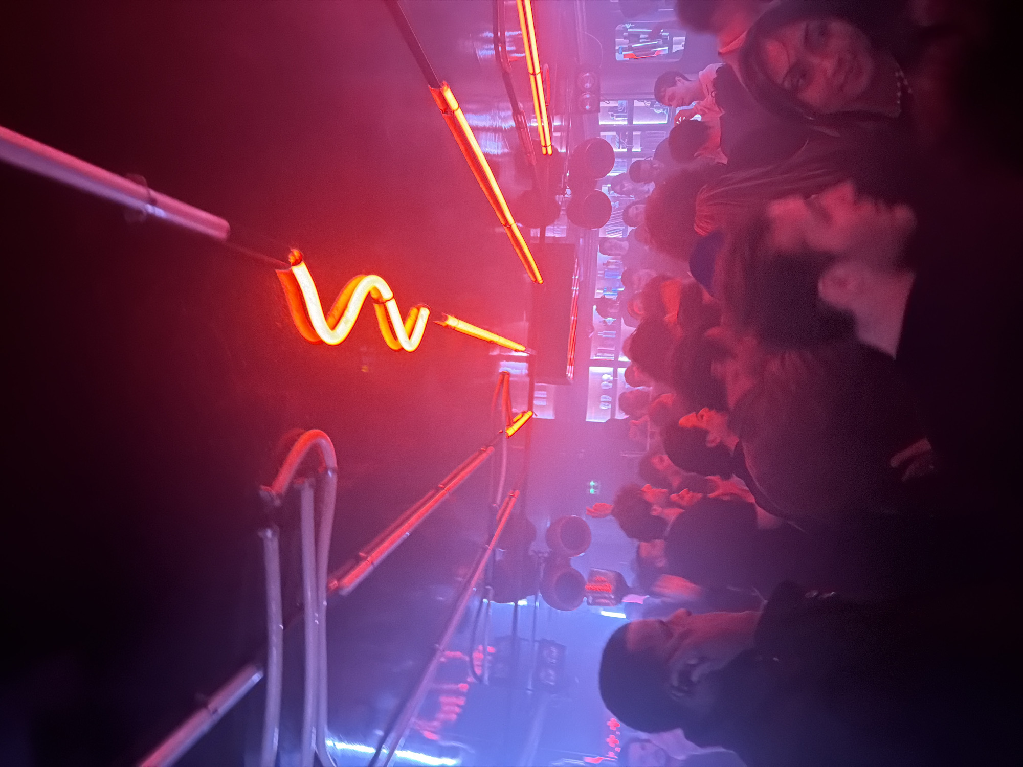 Early morning crowd gathered in dimly lit Paris interior