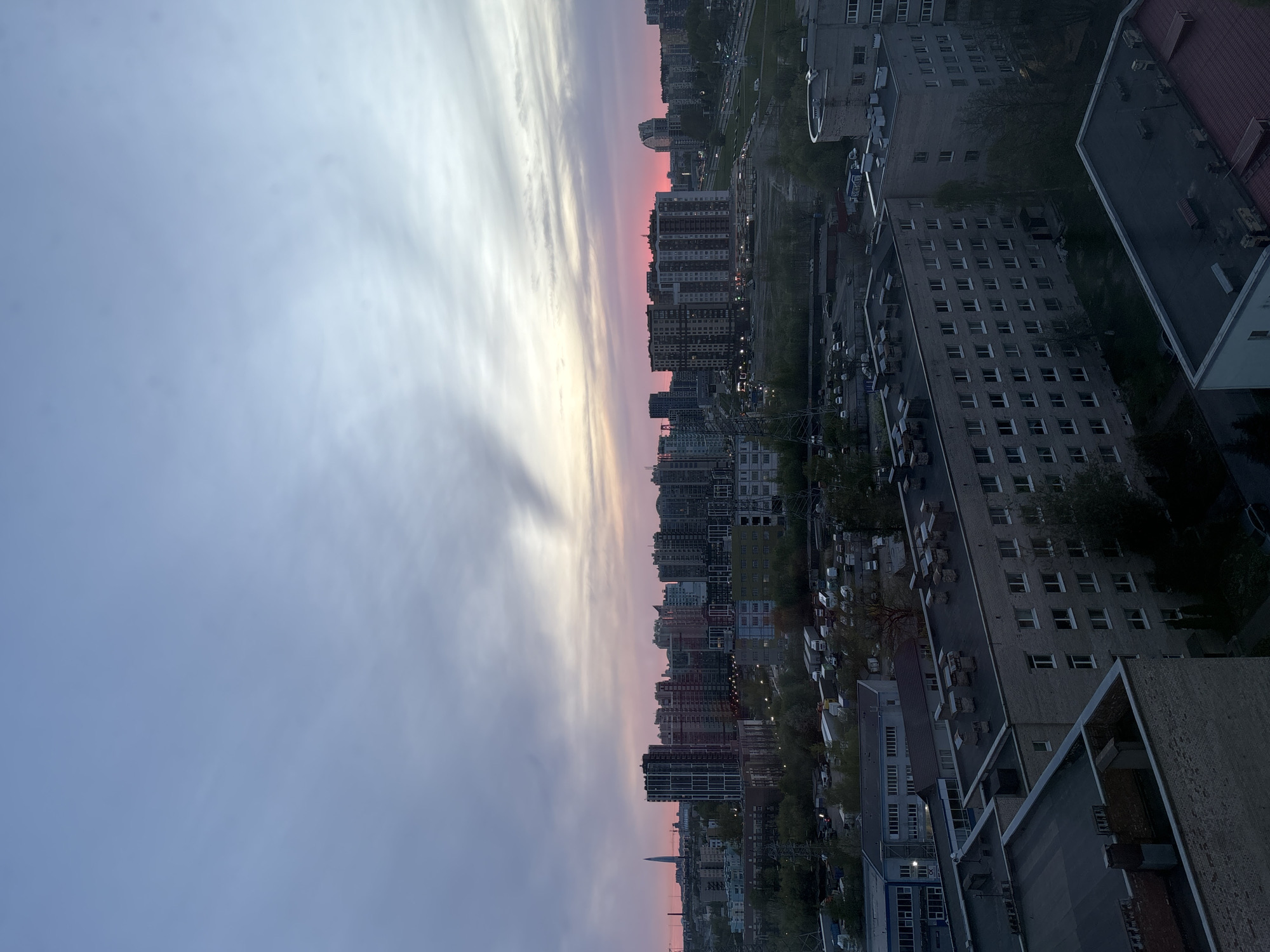 Twilight cityscape captured showing colorful sky over high-rise buildings