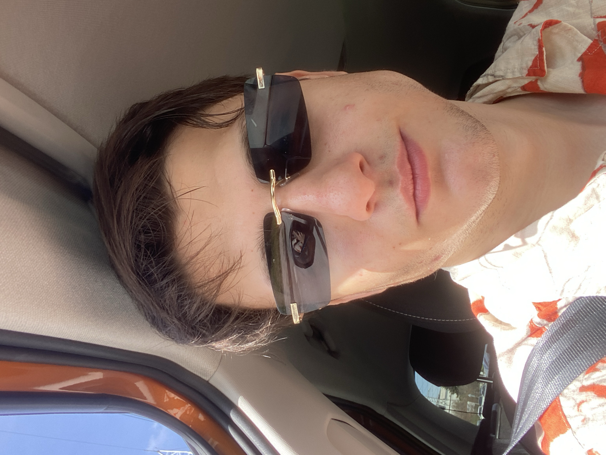 Man in sunglasses photographed in car driver's seat, Varna