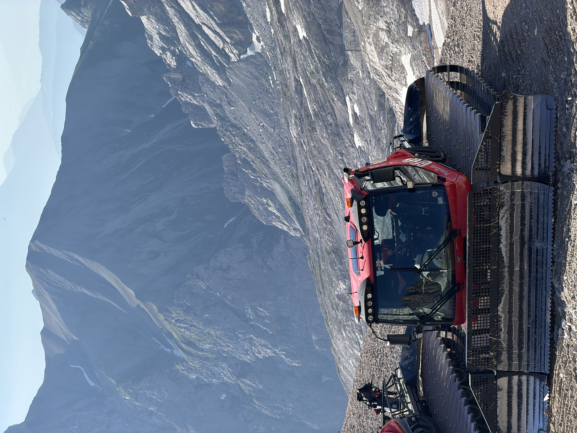 Mountain morning: groomer, coffee, and a rappel in the Alps