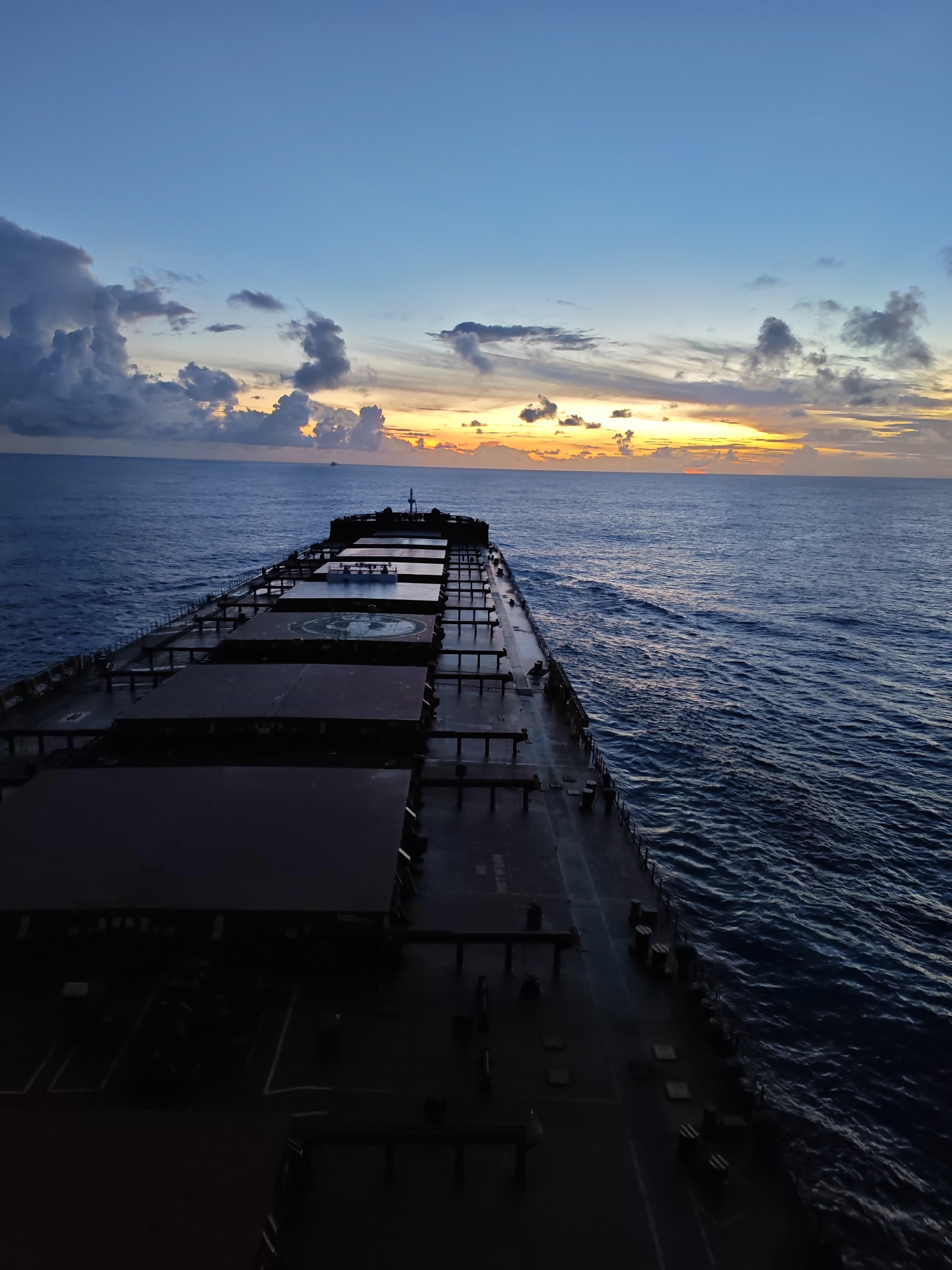 Cargo ship crossing the Indian Ocean at dusk