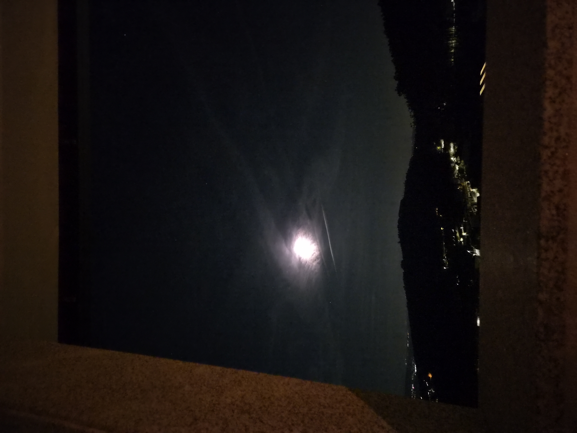 Moonlight captured reflecting on water in Barcelos, Portugal
