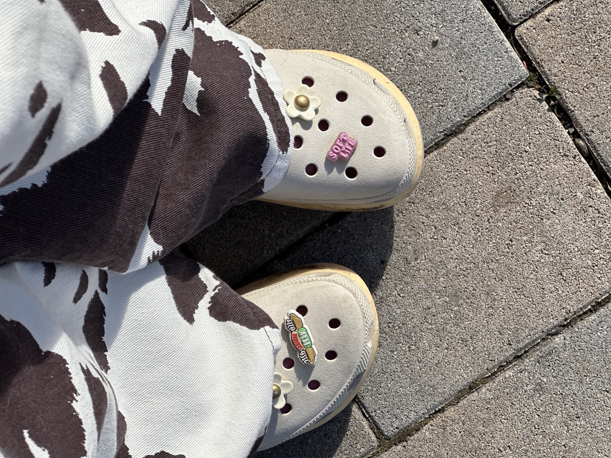 Person in decorated Crocs photographed on street in Šušanj