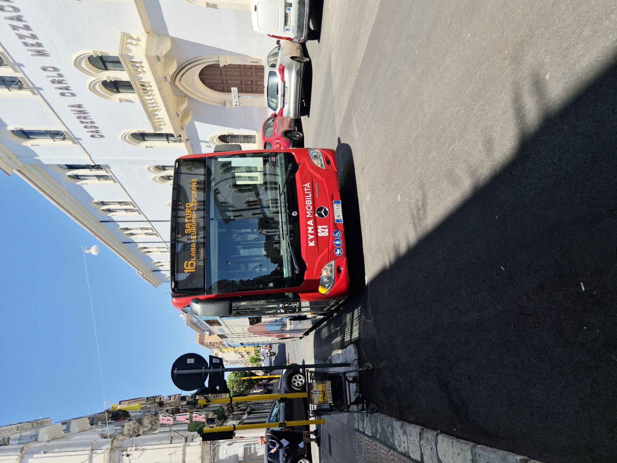 Ordinary street life along a Taranto bus route, mid-morning