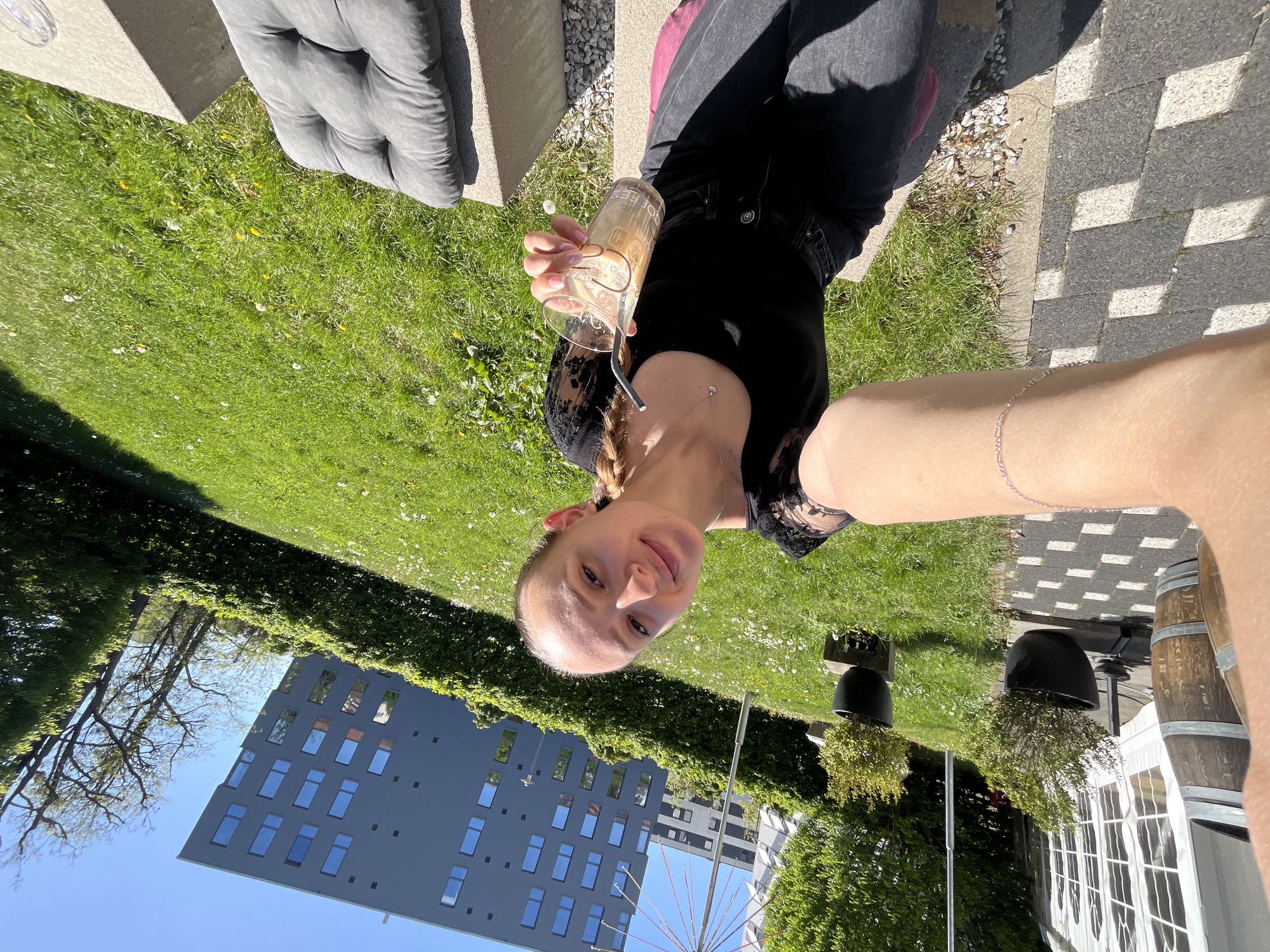 Woman enjoys iced coffee selfie moment in sunny Saarbrücken