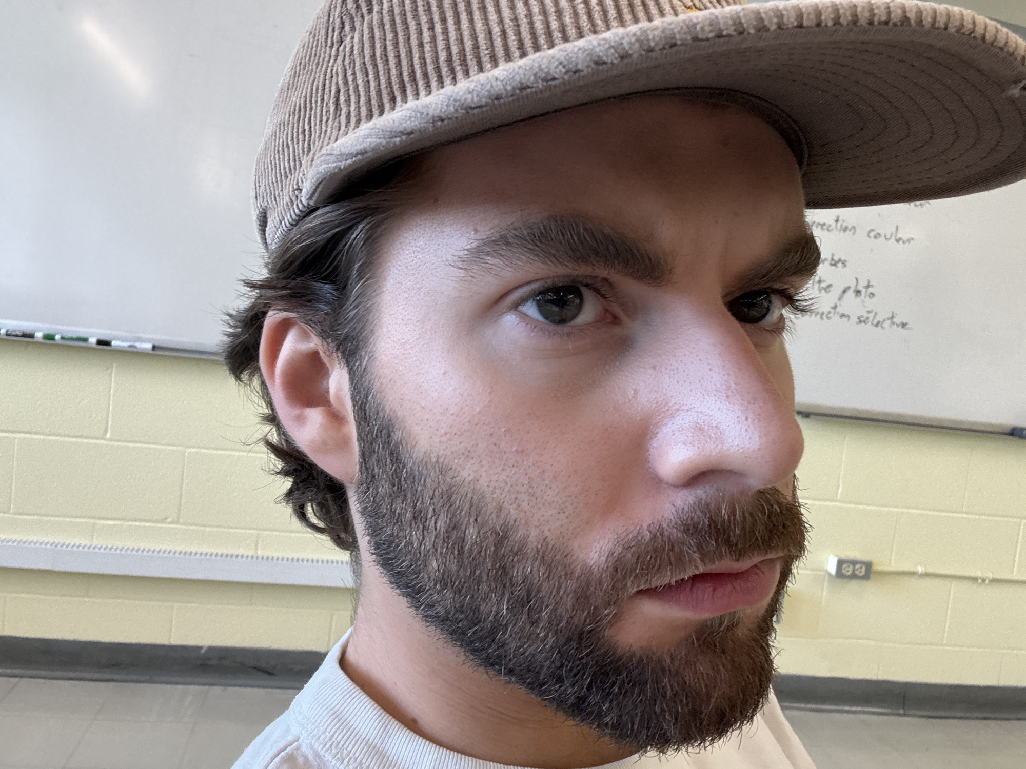Close-up profile portrait in Montreal, corduroy cap and beard