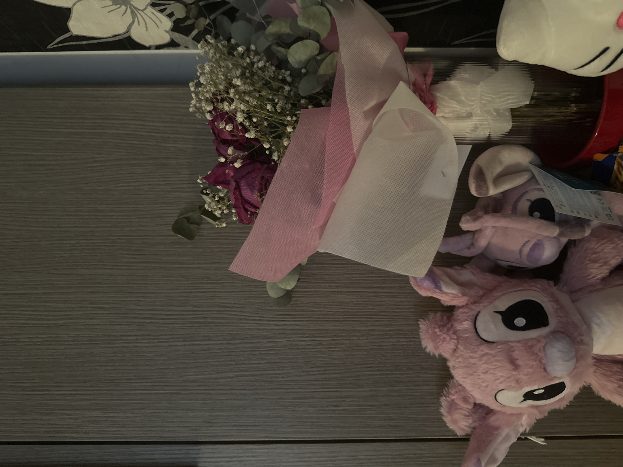 Casual home scene with flowers, plush toy, cartoon TV