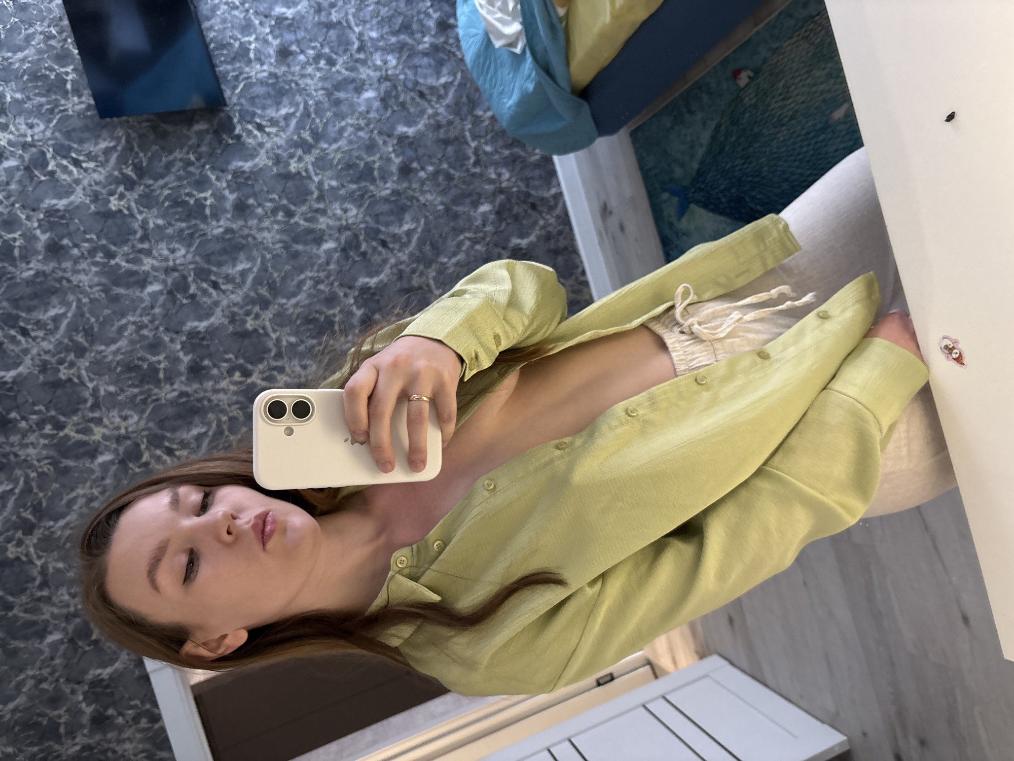 Woman takes indoor selfie with iPhone in Izhevsk
