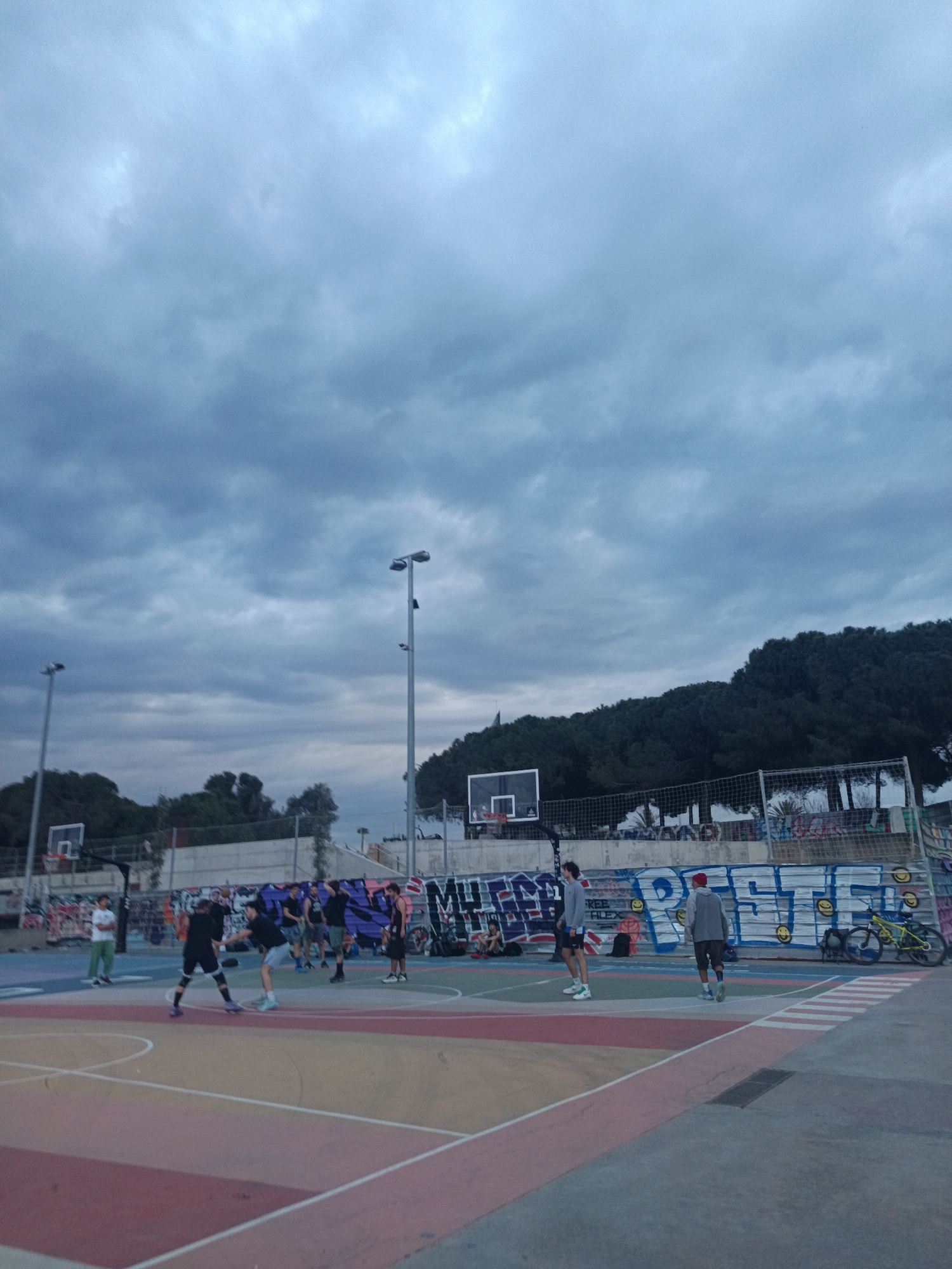 Basketball game and street art observed in Barcelona neighborhood