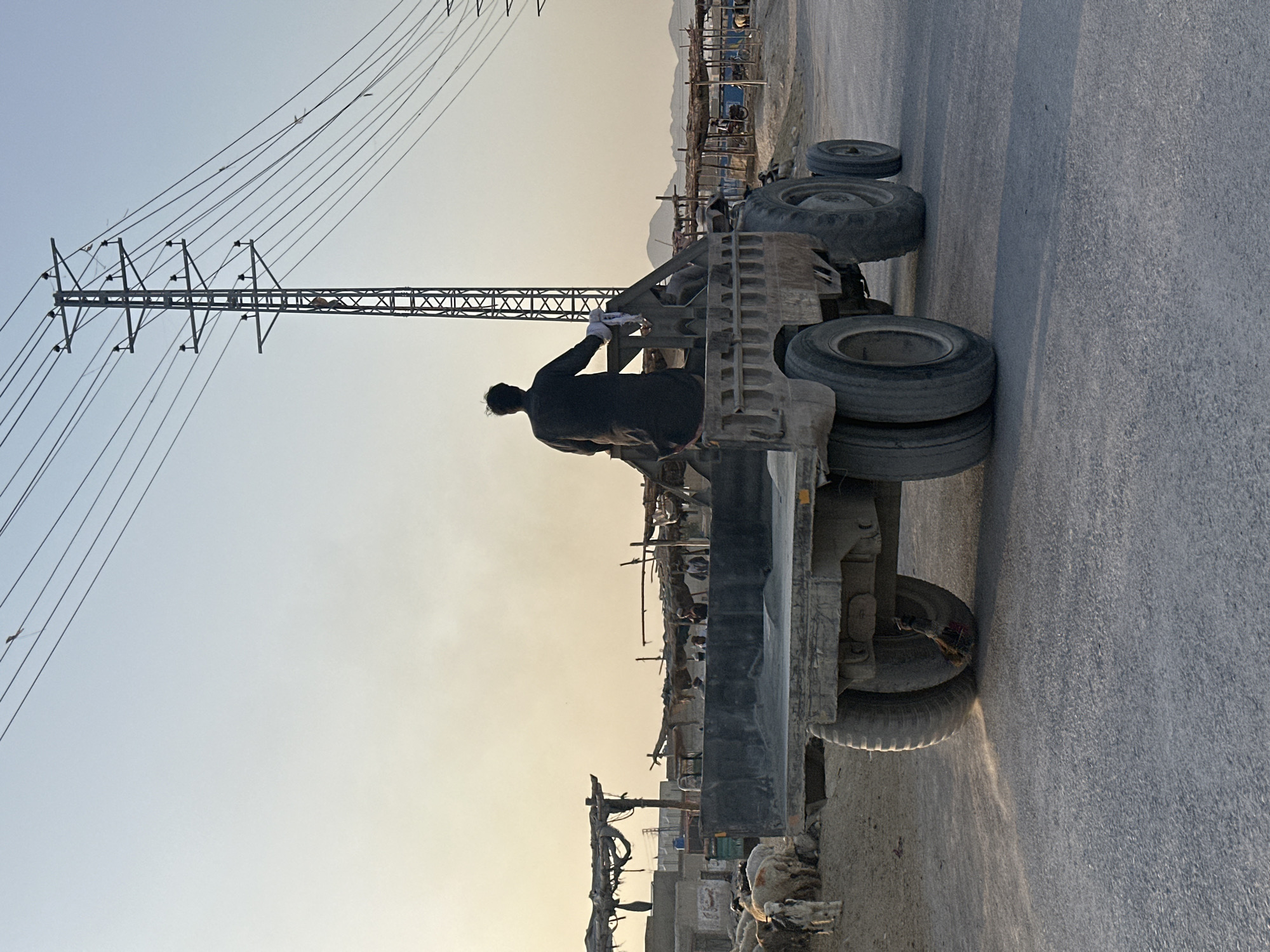 Standing atop a dirt-loaded trailer in Quetta