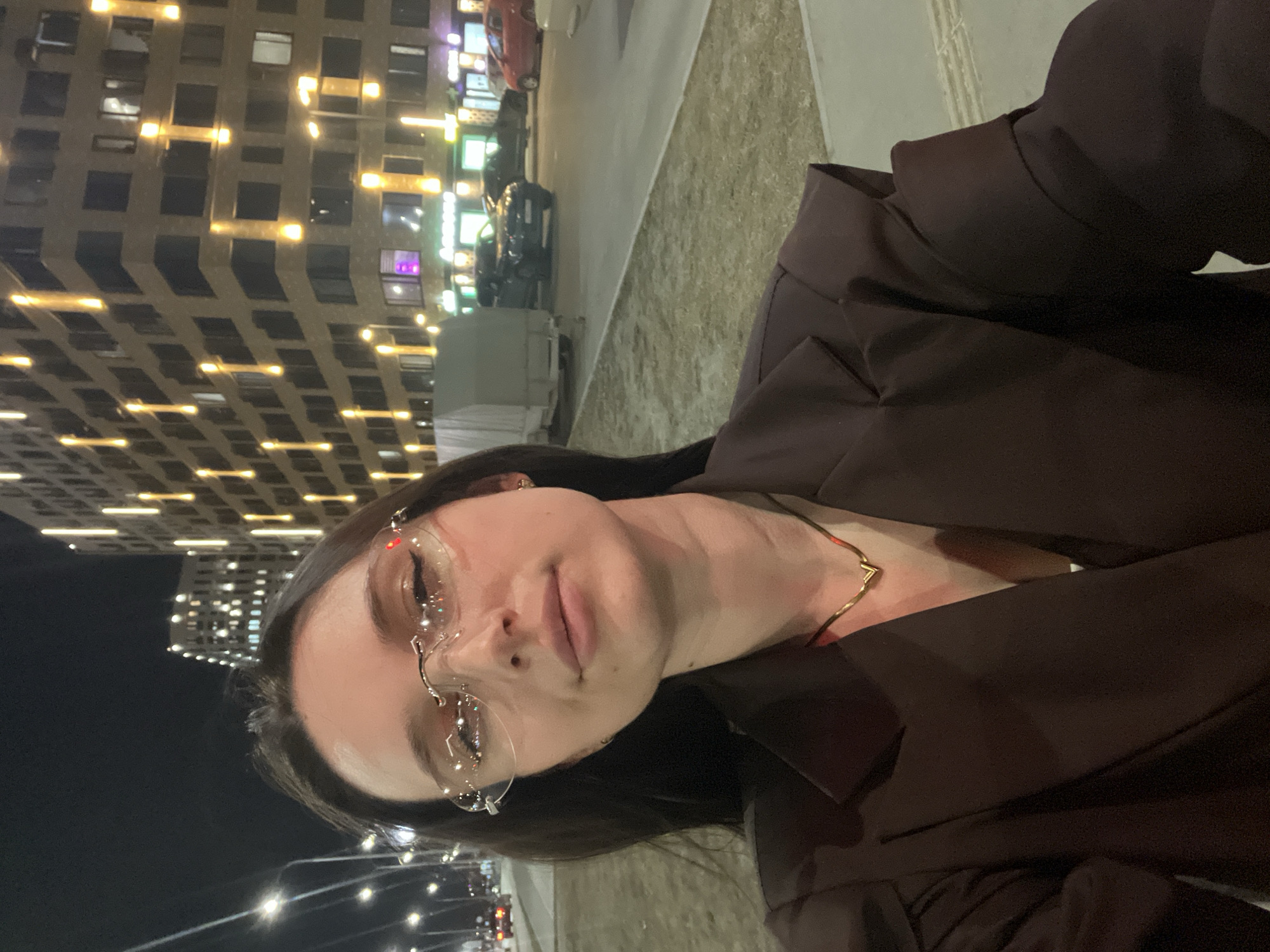 Woman documents evening street walk with selfies in Tyumen