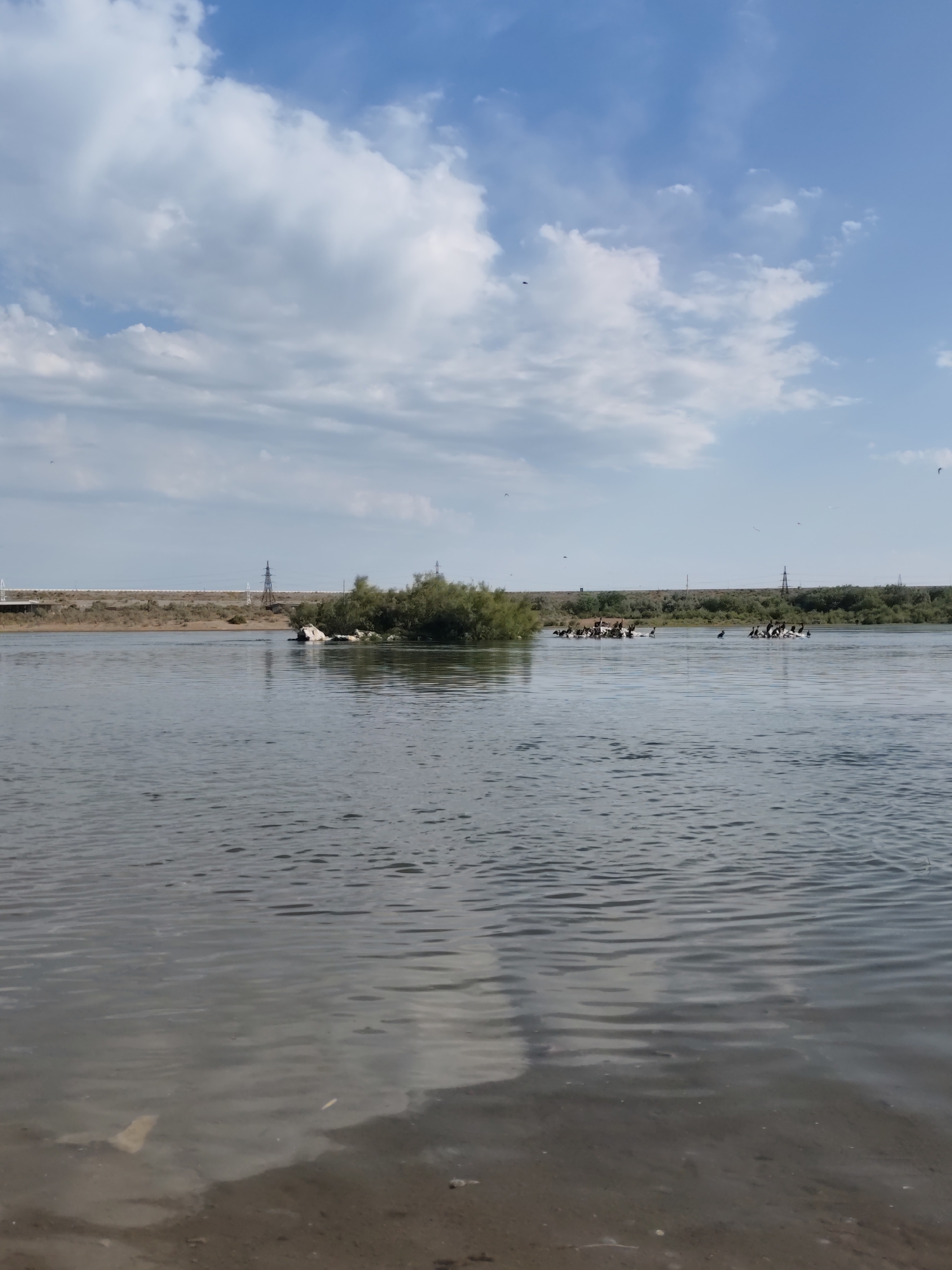 Calm river and open road near Şardara, Kazakhstan