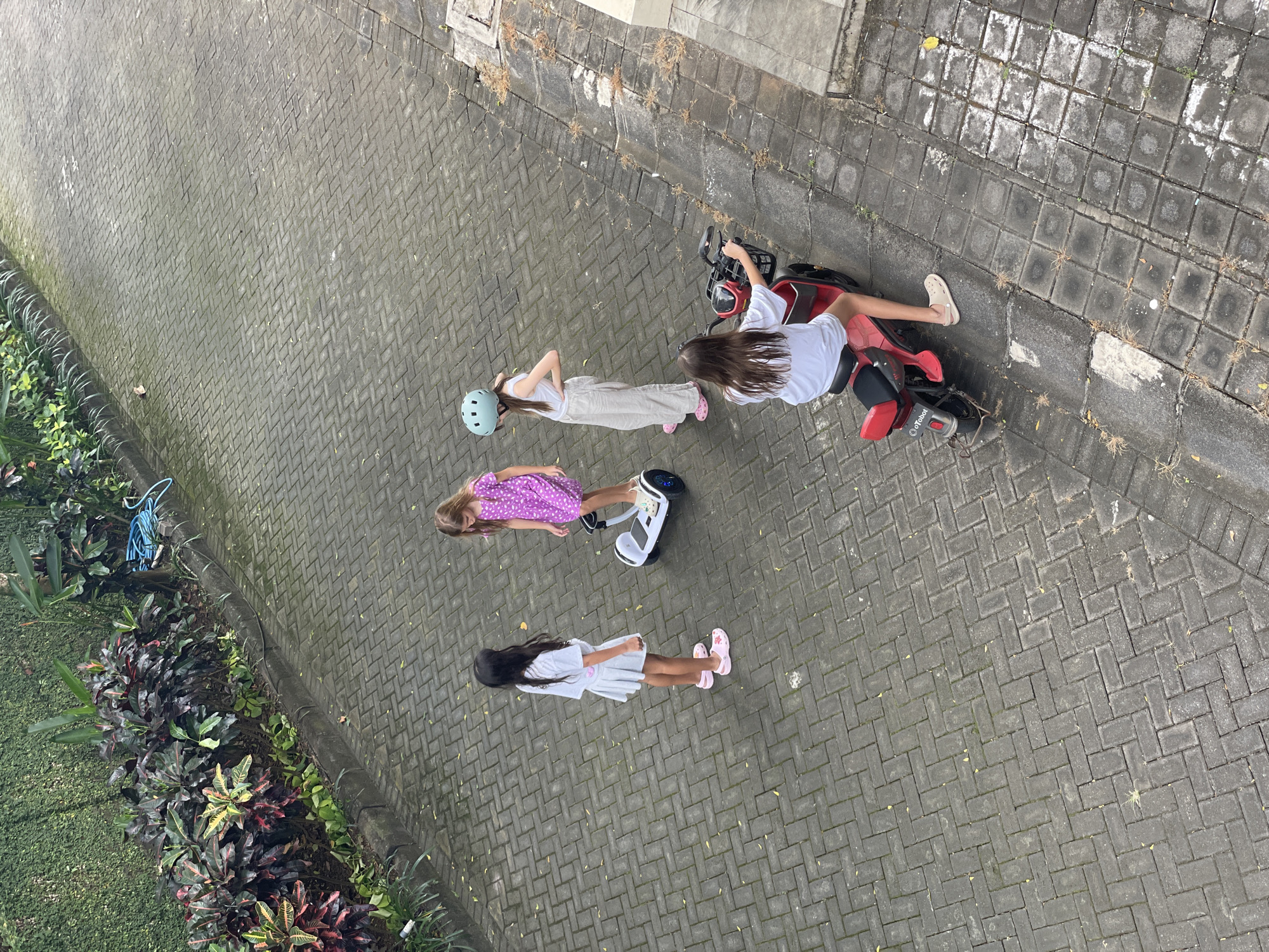 Early morning scenes of children playing, street traffic in Kuta Selatan