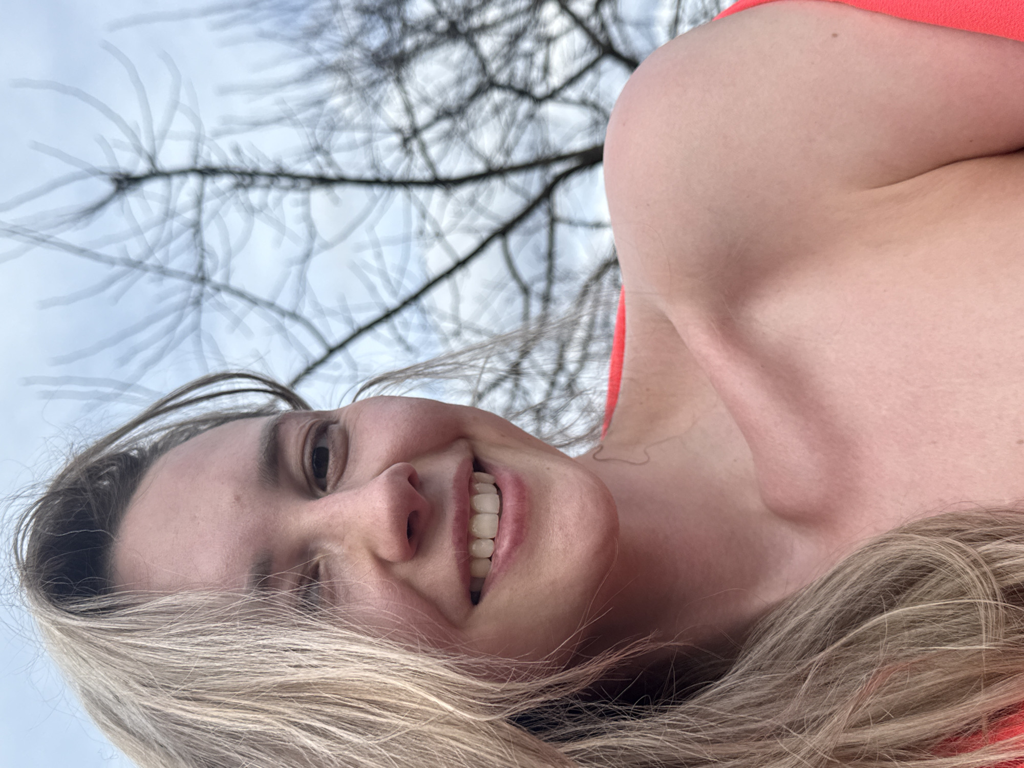 Woman poses for photos along riverbank in Chaikovsky, Russia