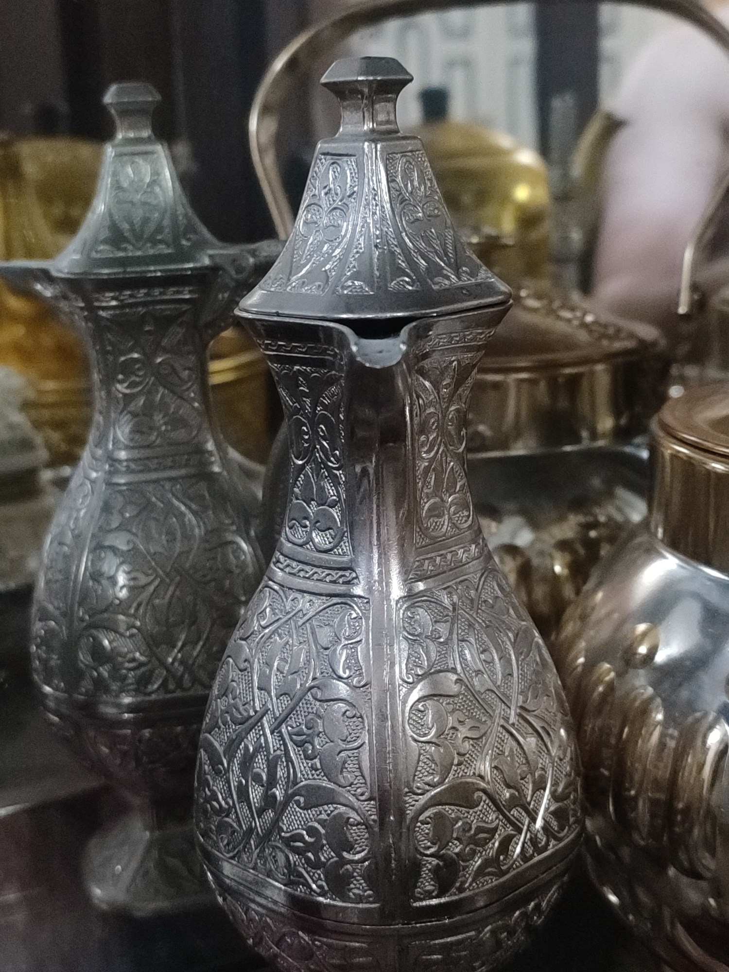 Ornate teapots, cups, and traditional crafts on display in Blang Cut