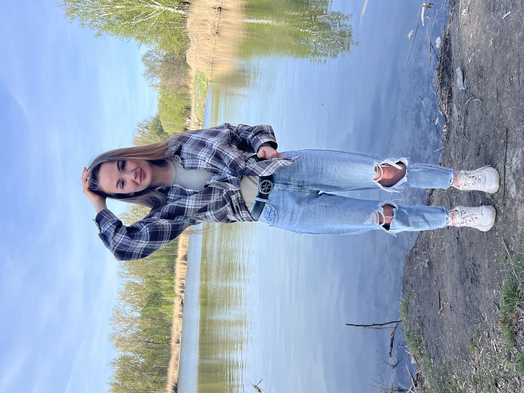 Young people gather for outdoor activities near water in Ciemne