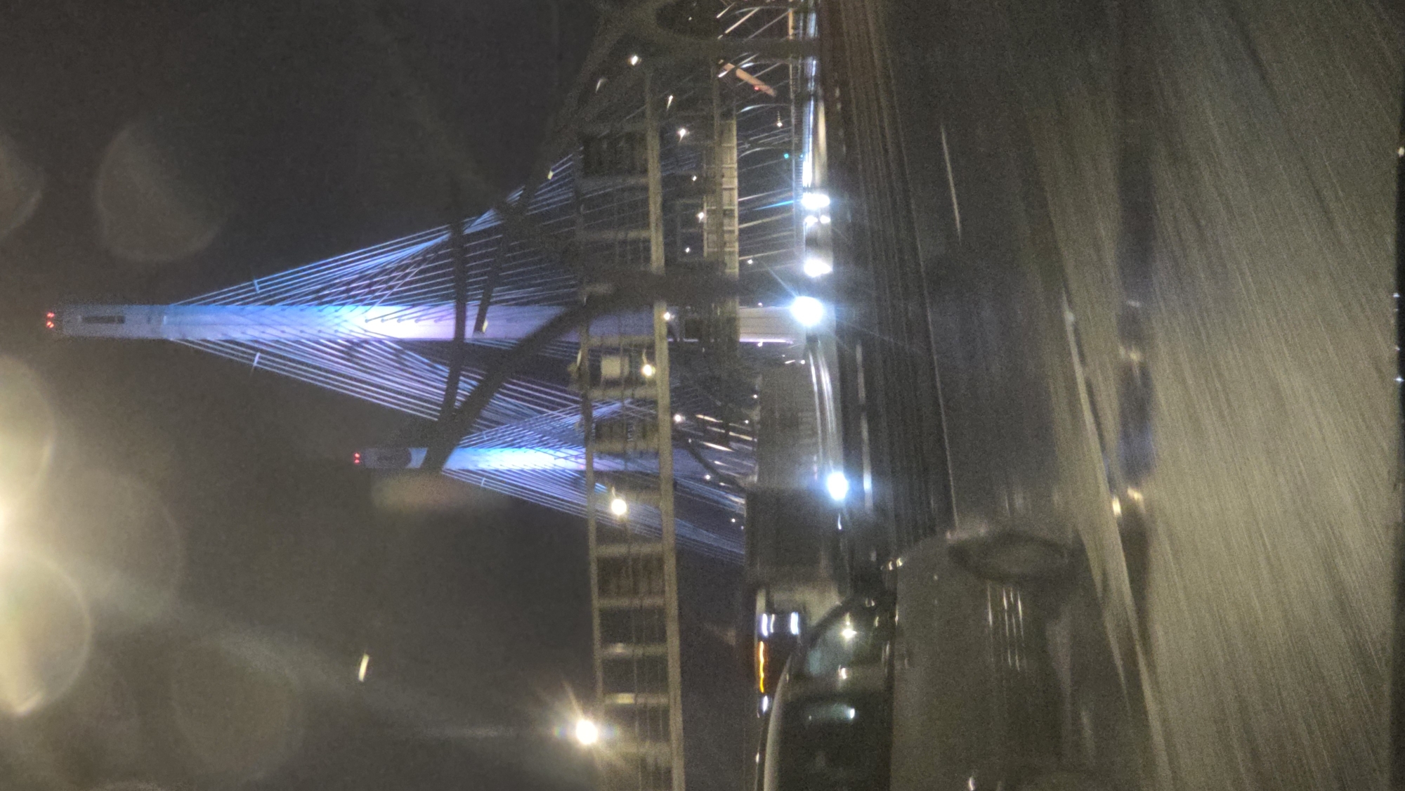 Blue-lit Saint Petersburg bridge captured in nighttime vehicle footage