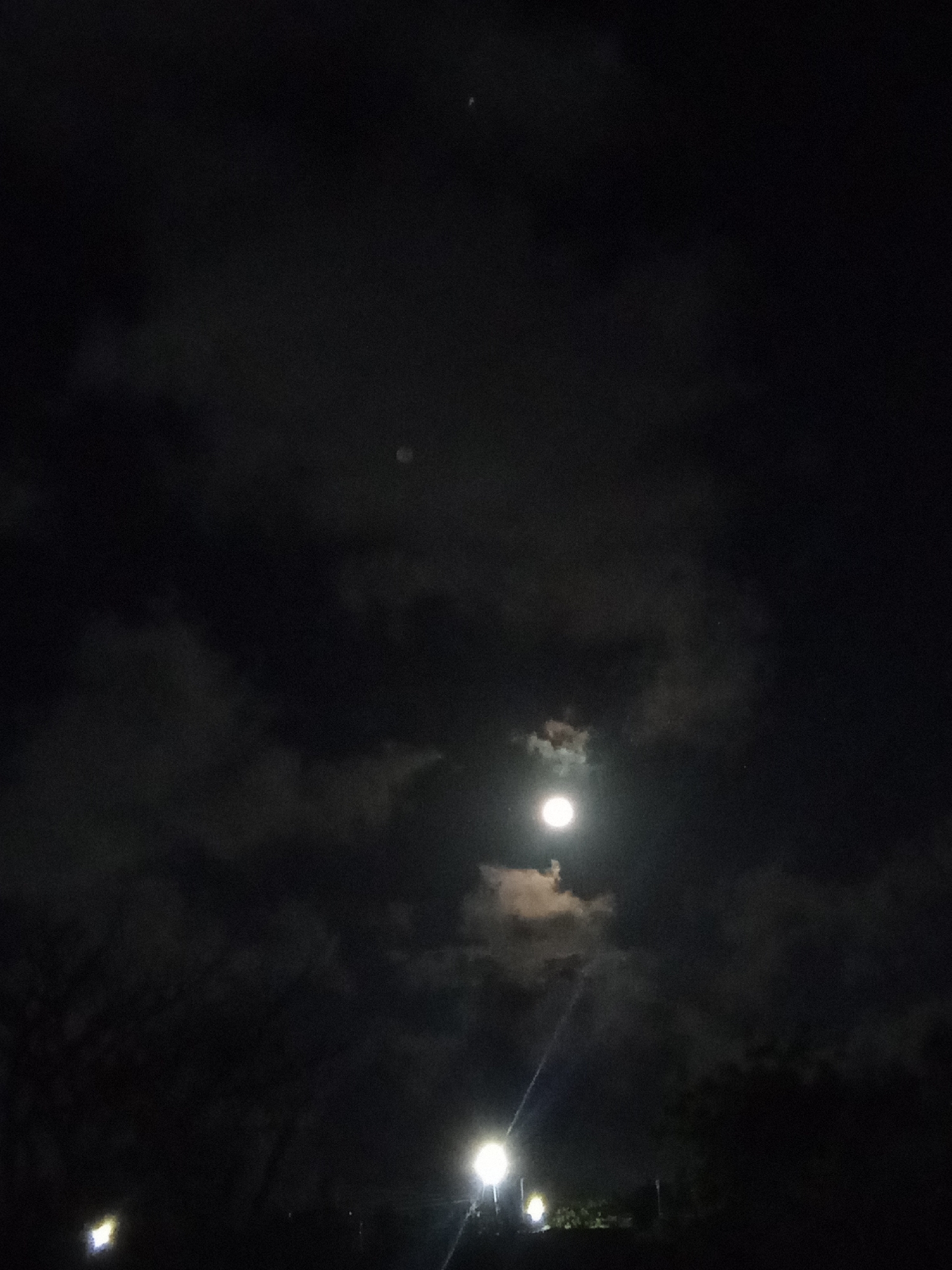 Full moon observed through clouds in Juan Griego, Venezuela