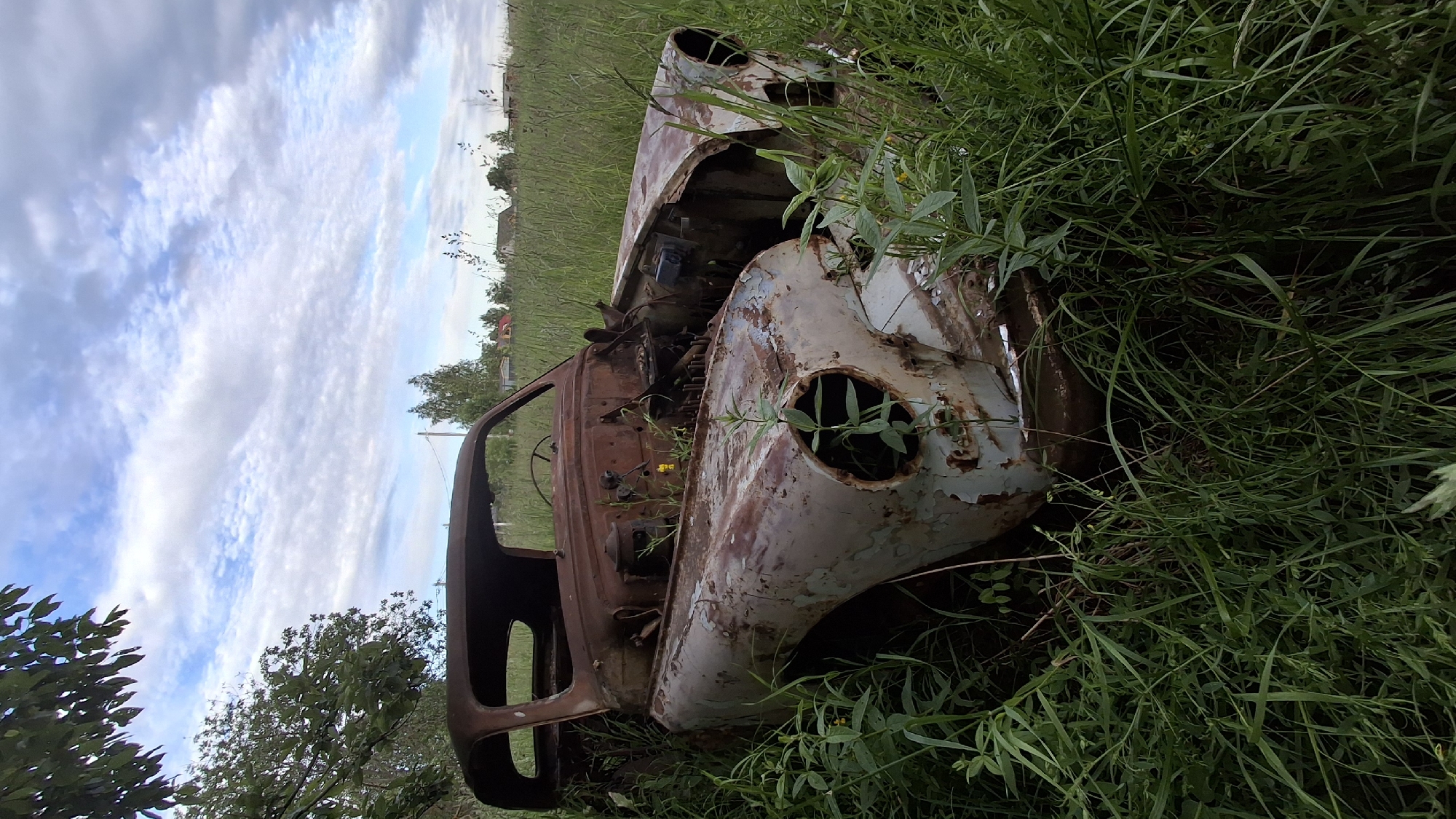 Kid explores field of abandoned construction vehicles in rural Russia